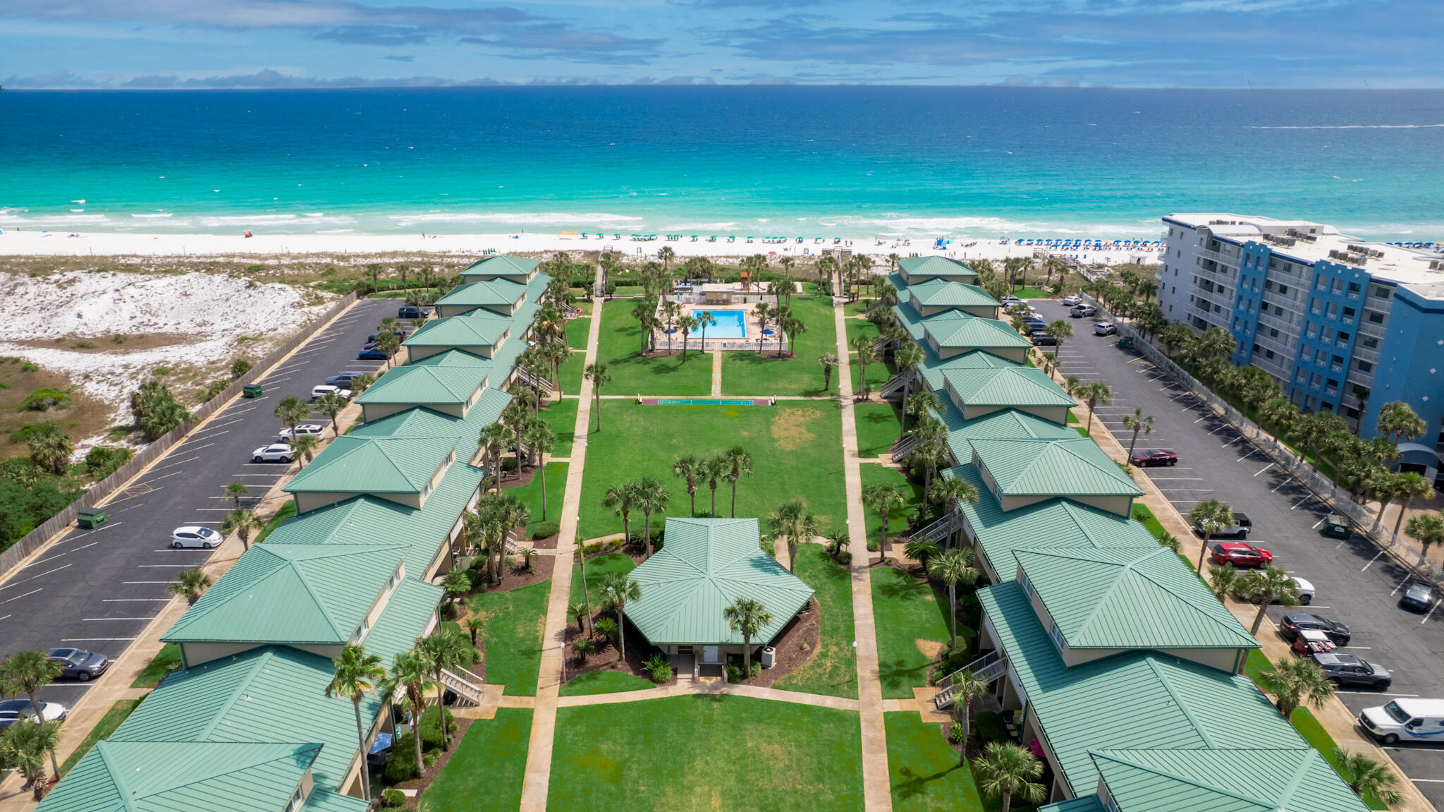 Experience the charm of coastal living at Seaspray with this inviting 1-bedroom, 1-bath condominium located on the desirable west side of the complex. Thoughtfully designed with an open layout, this residence offers comfortable space for family and guests, featuring a spacious upstairs bedroom and additional sleeping accommodations with a downstairs sleeper sofa.

The large ground-floor patio opens directly to Seaspray's expansive green space, creating an ideal setting for outdoor relaxation, games, and gathering after a day at the beach. Residents and guests enjoy a variety of community amenities including a pool, fitness center, sauna, laundry facilities, community room, grilling area, shuffleboard, open recreational lawn space, and a playground area.

Seaspray is known for its private beach access and wide stretch of sugar-white sand, offering an exceptional opportunity to enjoy the coastal lifestyle along the Gulf. Whether you are seeking a personal beach retreat, vacation getaway, or investment opportunity, this condo offers the perfect place to relax and make lasting beach memories.