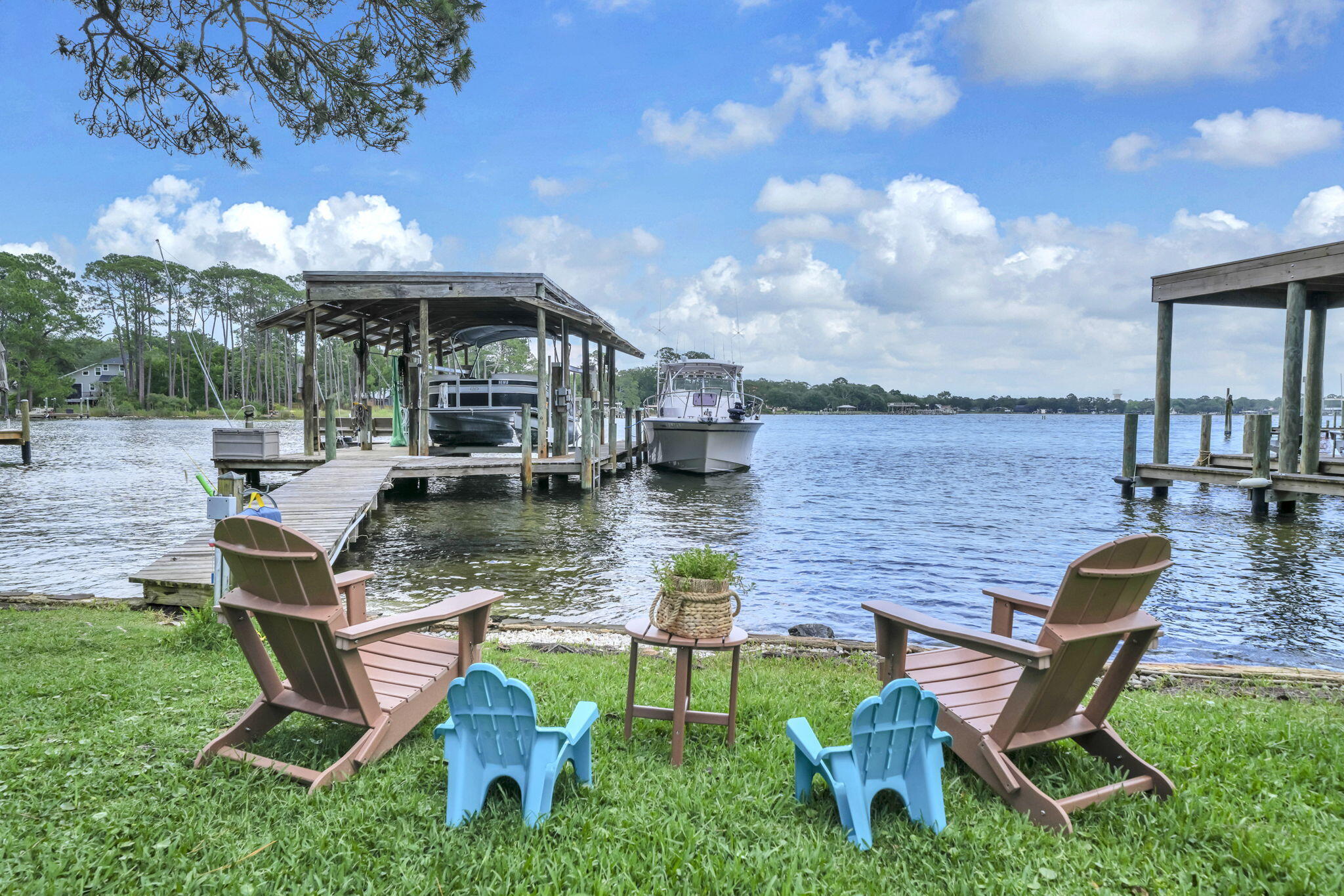 This exceptional home offers 70 feet of water frontage, a deep water slip and lift on Poquito Bayou. This property delivers the ultimate boater's lifestyle. Relax on the waterside while watching dolphins, sunrises, and beautiful skies over the bayou. Fish for trout or redfish on the dock, paddle board in the no wake zone, water ski on water that is smooth as glass, or sail until your heart's content! The home features 5 bedrooms, 3 full baths, and sweeping water views from open living spaces, the primary bedroom, and two of the guest bedrooms! The kitchen opens to the great room and dining room and features a stainless side by side refrigerator, a 5 burner gas stove (2026), dishwasher, and range hood. Custom cabinetry with crown and light rail, granite countertops, and the tiled backsplash completes this kitchen. Enjoy preparing meals for guests with water views of the bayou! The great room has stunning 12 foot vaulted ceilings with beams. Even the stone façade for the gas fireplace extends 12 feet to the ceiling! New luxury vinyl plank (2026) and the original stone flooring blends traditional and modern design beautifully and elevates the space by adding warmth. There are two gas fireplaces in the great room creating a cozy ambiance for entertaining. The space in the great room could be designed multiple ways with a dining table overlooking or living room overlooking the bayou.  The main floor features the primary bedroom and bathroom, two guest bedrooms and a guest bathroom. The primary bedroom has expansive views of the bayou. Sliding doors to a cozy space on the balcony offers a sitting area for reading and relaxing while watching the dolphins play! The ensuite primary bathroom has a vanity with modern countertops, faucets and fixtures. The tiled shower features a frameless shower door and custom tiled surround. The walls are tiled with white subway tile with a brick lay design. The guest bedrooms have large closets and the guest bathroom features a large vanity and walk in, tiled shower. The carpet in all the bedrooms is new (2025). Sliding glass doors in the primary bedroom allow access to the upper deck of the solarium. The solarium has double height ceilings (18 feet) and a floor to ceiling wall of windows! The views from the upper balcony and the lower area of the solarium are breathtaking and panoramic! There is a built in horizontal planter that features an herb garden. The traditional rock flooring, iron railing, and staircase makes this space spectacular! The basement has been updated to feature a kitchenette, two guest bedrooms, a full bath, and an extra storage area! Guests enjoy a private retreat with water views of the bayou. The climate controlled garage is a flexible space and ideal for a home gym, workshop, prized car collection, or game room with a pool table.  Store your fishing, boating, and beach equipment in this flexible heated and cooled space.  Poquito Bayou is only minutes to the Choctawhatchee Bay and the Gulf! The neighborhood has a boat launch, park area and public beach on the bayou. The Poquito Bayou neighborhood is only minutes to the Airport, restaurants, shopping, and the beach! Additional home features include a 26kw Generac whole house generator (2025), new copper wiring (2024), a geothermal HVAC that cools the solarium and walk out basement and a second new HVAC for the main floor, a 30 year dimensional shingle roof, an open deck with water and gas and are tractable awning, a dock with electricity and water, decked attic space, new insulation, corrugated hurricane shutters, new millwork, new solid core doors with hardware and new HVAC duct. The whole house generator provides peace of mind and their is a storm or bomb shelter with a poured concrete ceiling and a steel door. The dock has water for cleaning boats and jet skis and electricity for the boat lift. The concrete block construction on the water provides storm impact resistance, long term protection against rot and termites, and is a premier building material for waterfront properties making this home a rare find on the Emerald Coast. Buyers to verify all dimensions and information.