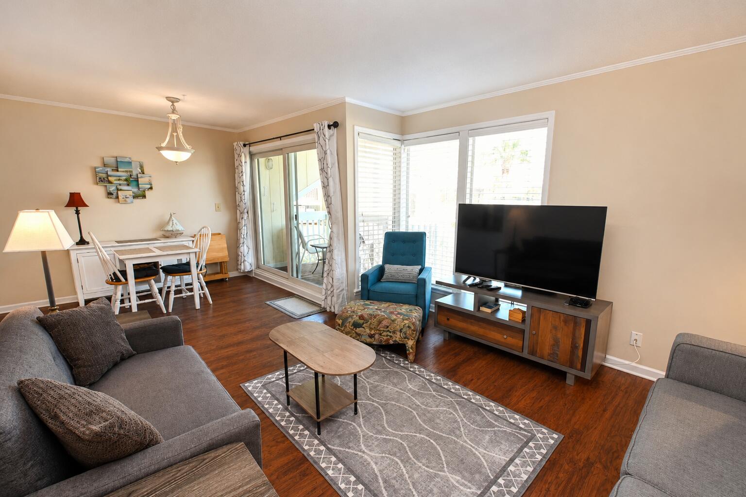 Imagine basking in the sun just moments away from the beach, where community and convenience blend seamlessly into the perfect coastal lifestyle. In this vibrant neighborhood, golf carts rule the streets, an effortless way to shuttle your beach gear, family, and friends without the hassle of carrying everything on your back. Sandpiper Cove offers convenient golf cart parking and dedicated car spaces throughout the property.  Explore the entire property, visit the various pools, or venture to the Louisiana Lagniappe on premises for a delectable meal.
Step into this charming first-floor unit, where accessibility meets comfort. With minimal steps to navigate, you'll enjoy the luxury of southern exposure on your private deck, ideal for soaking up the sun all day long. Picture yourself sipping your morning coffee under the warmth of the sun, relishing in the tranquility of your surroundings, far from the bustle of neighbors. As twilight falls, retreat to your deck for stellar views of the night sky while your laundry is just a stone's throw away, making chores feel effortless allowing you to remain in your unit while you stay comfortable while your clothes wash and dry. The property is designed with your privacy in mind and you'll appreciate the secluded area where you can stroll to your car or walk your dog in your pajamas without a care in the world.  The lower traffic area and ample parking enhance the ease of life here. The nearby activity center is just a few doors down.  Engage with fellow owners during games, dances, and various social gatherings for the Community spirit to thrive and provide excellent opportunities to make new friends.  There is a fun nine hole pitch and putt golf course too that is no charge and no need to make a tee time.  Just hop on and play. Finally, don't miss the opportunity to take the short walk down the hill and go over the quaint wooden bridge that leads you over the canal to get to the pickleball and tennis courts where friendly competition awaits. This complex is more than a residence, it's a lifestyle, perfectly situated for both relaxation and community engagement.