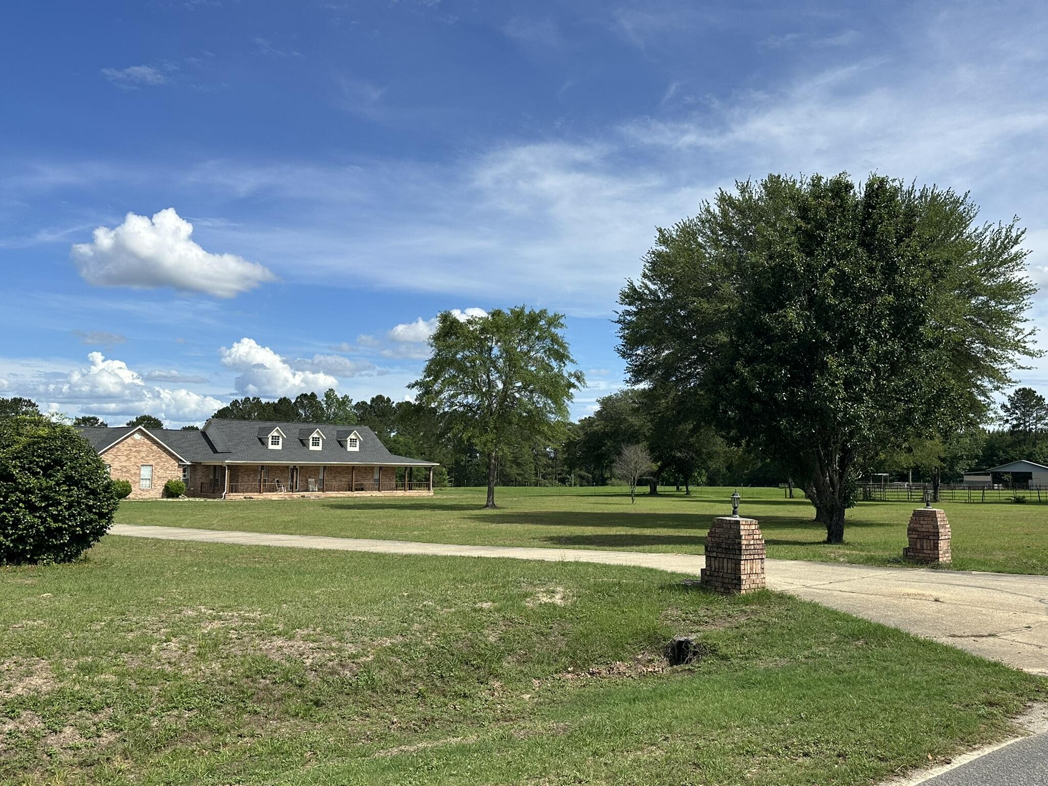 Shown by appointment only. Expansive 230+/- acre farm and recreational retreat in the Laurel Hill, Florida and Florala, Alabama area, thoughtfully set up for both cattle and equestrian use. The land is fully fenced and cross-fenced with established pasture, complemented by multiple shooting houses and food plots, making it well-suited for both agricultural and recreational use. A large pond and multiple flowing creeks enhance both function and natural beauty, while mature, towering oak trees add to the character of the property.
A lighted horse arena and well-equipped barn with game cleaning station support a variety of agricultural and outdoor pursuits. The primary residence offers a welcoming layout with 3 bedrooms, 2 baths, an open living and kitchen design, oversized mudroom and laundry space, and spacious front and rear porches. A separate 3 bedroom, 2 bath cabin provides space for guests or weekend use, complete with its own entertainment area and fish cleaning station.

The property is located just minutes from Laurel Hill, with access to Lake Jackson in Florala, shopping in Crestview, Florida, I-10 corridor access, Destin beaches, and area military bases. The offering also includes two additional parcels located in Laurel Hill, Florida, accessed through the Alabama acreage. Portions of the property may include wetlands and natural water features.