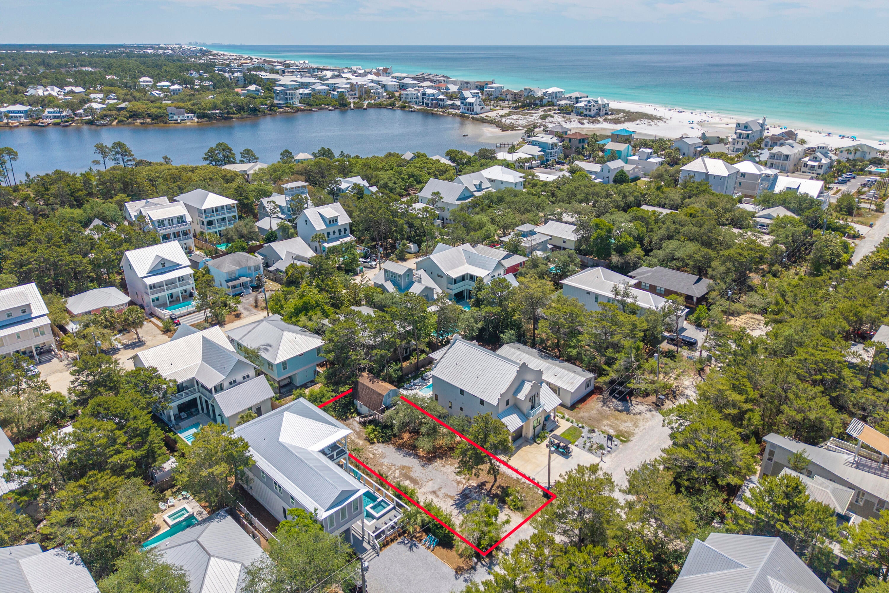 Rare opportunity to own a fantastic homesite south of 30A in the heart of Seagrove, just a few blocks from the Gulf and the beautiful shores of Eastern Lake. This 50x108 lot totaling approximately 0.12 acres is surrounded by luxurious homes and offers an exceptional setting to build your dream beach retreat in one of 30A's most desirable locations. Native oak trees create a charming Old Florida feel, while the easy gravel drive and peaceful setting enhance the property's appeal.
The property currently features an approximately 520 square foot structure with separate upper and lower level entrances, offering potential for restoration, guest quarters, pool house use, or an ADU conversion while planning a future build. The upper level includes a bedroom, bathroom, walk-in shower, and deck overlooking the trees, while the lower level offers concrete floors, wood ceilings, and a kitchenette. Ideally in Flood Zone X. 
Enjoy easy access to Eastern Lake, one of South Walton's rare coastal dune lakes with direct Gulf access, featuring a scenic boardwalk plus newer parking and bike parking conveniently located at the end of Williams Street off Eastern Lake Road. Paddleboard, boating, and fishing enthusiasts will love the convenient proximity to the nearby Eastern Lake Boat Launch. Perfectly positioned near Old Florida Fish House, Coastside 30A, Beachy Bean Coffee Co., Greenway Station, and the trails of Point Washington State Forest, this is an ideal spot to embrace the 30A lifestyle! Public water, sewer & electric already tapped so low expense to prepare the lot for your build. No HOA also gives you more freedom to create your dream home. Buyer will still need to comply to standard Walton County setbacks.