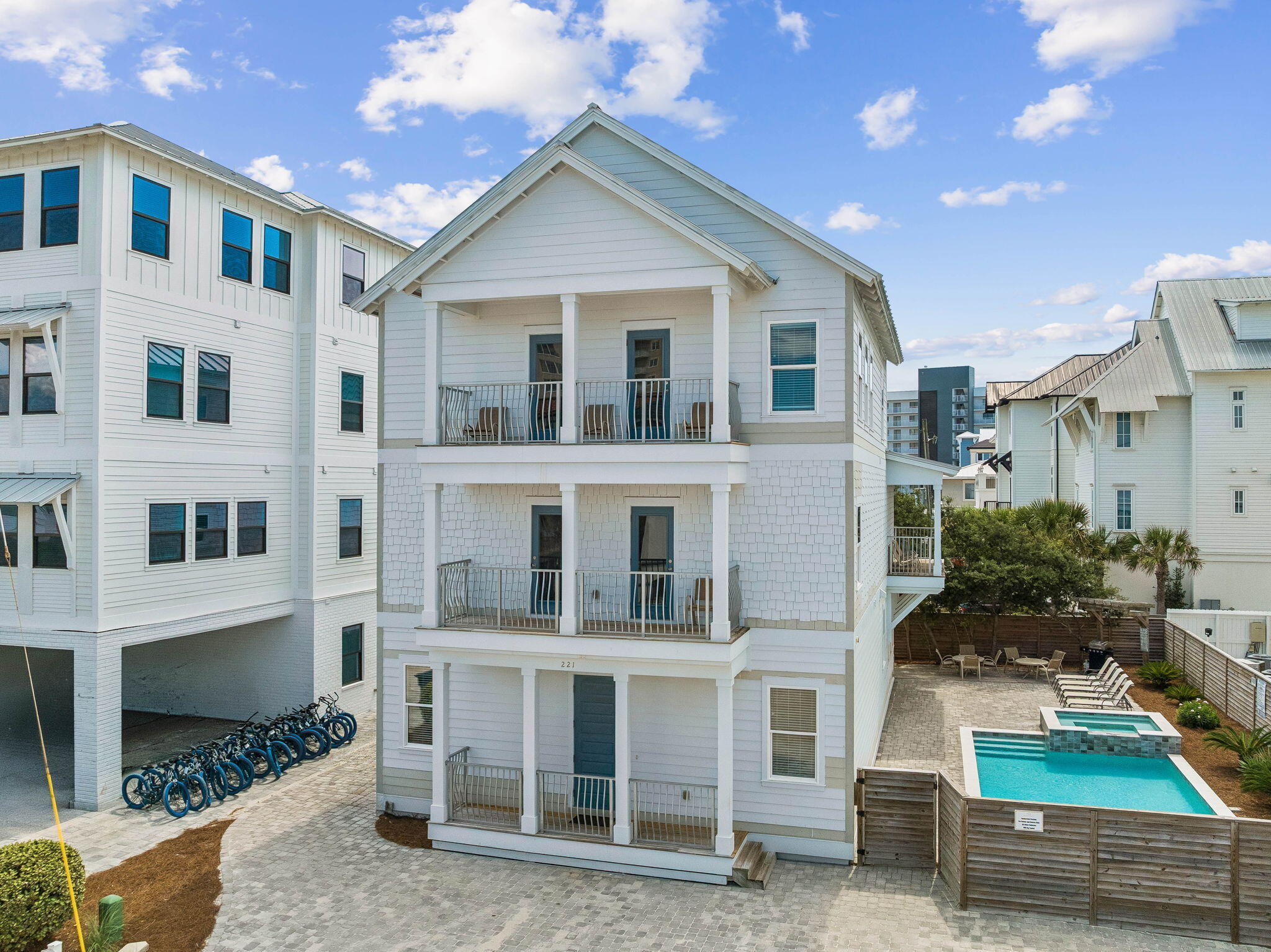 Welcome to 221 Norwood Drive, an exceptional 8-bedroom, 9-bath coastal retreat located just steps from the sugar-white sands of Miramar Beach. Thoughtfully designed across three spacious levels, this residence combines generous scale, Gulf views, refreshed interiors, and an outstanding location for both private enjoyment and vacation rental use.

The main living area has been recently updated with new furnishings, creating a brighter, more elevated setting for gathering and entertaining. An open-concept layout connects the living room, dining area, and kitchen, while abundant windows fill the space with natural light. The kitchen offers stainless steel appliances, ample cabinetry, extensive counter space, and a large island well suited for hosting groups.

Each bedroom includes access to a private bath, providing comfort and separation for owners and guests alike. Multiple living and recreation spaces allow larger groups to spread out, while Gulf-facing balconies extend the experience outdoors. Outside, the private resort-style pool and surrounding lounge areas offer an inviting setting for relaxing after a day at the beach. One of the property's most compelling features is the direct path from the backyard to the neighboring beach-access boardwalk, creating an exceptionally convenient connection to the Gulf without the need to cross a busy road.

With its 8-bedroom configuration, expansive gathering areas, private pool, multiple balconies, and remarkable proximity to the beach, 221 Norwood Drive is well positioned as a primary residence, second home, or income-producing vacation rental. Its layout and location offer the features guests consistently seek, along with the flexibility for a future owner to refine the rental strategy and maximize the property's potential.

Conveniently located near acclaimed dining, shopping, golf, boating, and family attractions, this Miramar Beach retreat delivers the space, accessibility, and coastal lifestyle that make the Emerald Coast so desirable.
