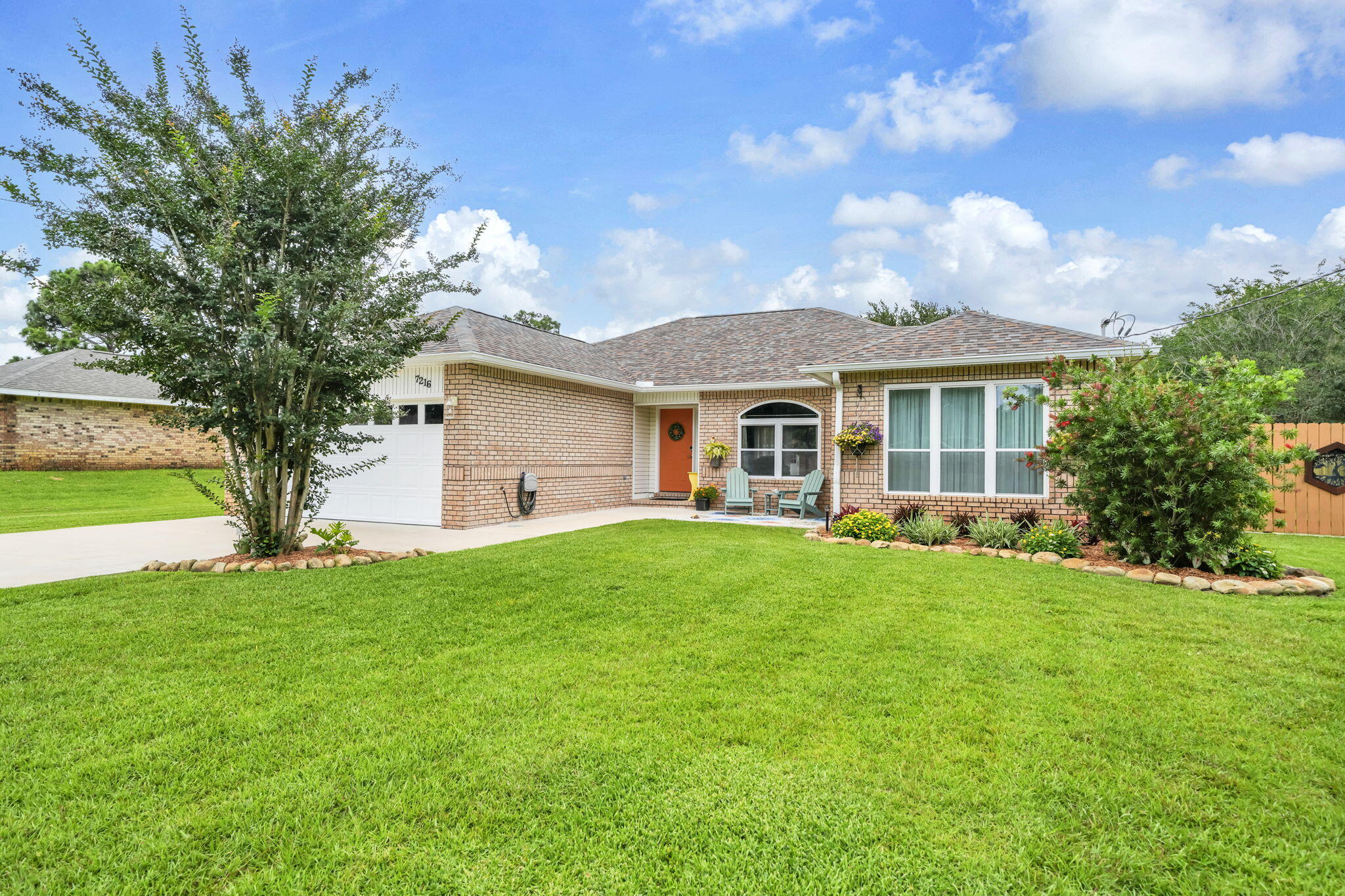 METICULOUS 3B/2B home on almost a half acre plus 2-story 24'x24' WORKSHOP, dedicated RV parking and all the amenities of Holley-By-The-Sea.  This warm and inviting home features a split bedroom floorplan and updated kitchen with high-end appliances, reverse osmosis instant hot water, a large island and plenty of cabinets.  Highlights include NO CARPET, upgraded vanities in both bathrooms and a spacious 2-story garage with  insulated garage doors, abundant storage space and easy-to-clean epoxy floors. This house stays show-ready!  Roof was replaced in 2021 and a brand new water heater was just installed in 2025.  An outdoor person?  Then you will love the beautifully-landscaped backyard!  Relax on the patio under the pergola, hang out among the flowers under the perfect shade tree or enjoy your favorite hobbies in the workshop, complete with 220 volt/50 amp and plenty of second story storage.  Even more room for yard equipment can be found in the separate shed (installed on concrete foundation in 2025).  Photos really capture the warmth and beauty of this property.  Schedule your appointment to see it in person, because it's not likely to last long.  * Disclosure:  Ring system does not convey.  Washer and dryer to remain and convey as-is.