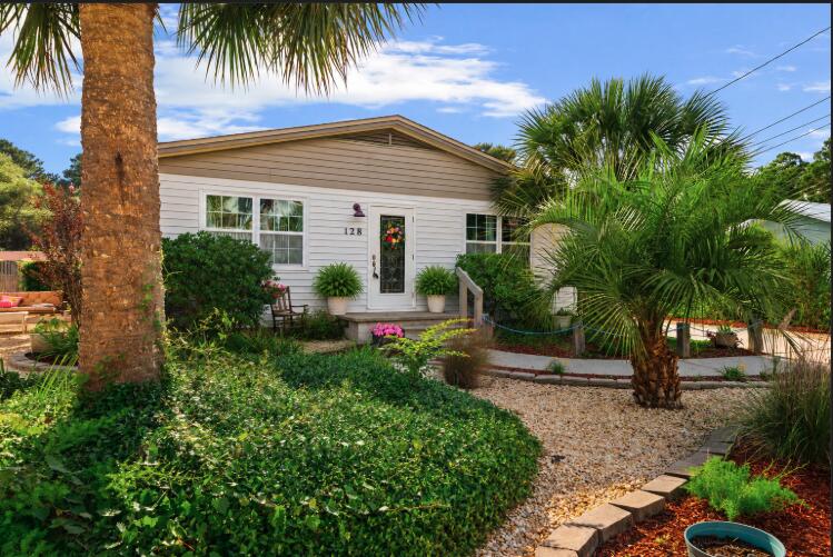 Beautifully maintained coastal home in a quiet, golf cart-friendly community just 0.3 miles from the beach! This 3-bedroom, 1.5-bath home offers low-maintenance living with privacy, charm, and outdoor entertaining space. Features include quartz countertops, custom ceiling-height cabinets, stainless steel appliances, vinyl plank flooring, textured walls/ceilings, upgraded baseboards, fresh paint, and hurricane impact windows with Smart Sun features.

Enjoy a private backyard oasis with a fish pond and fountain, fire pit, 10x12 gazebo, and a spacious 408 sq ft paver patio. The fully fenced yard includes a 6-ft privacy fence, RV hookup, storage shed, irrigation well, and plenty of parking for boats, RVs, golf carts, and multiple vehicles. The oversized 16x24 garage offers room for a car, golf cart, and storage.

Additional highlights include a private outdoor shower, updated vanities, matching ceiling fans, vinyl siding in excellent condition, annual termite/pest maintenance, and room for a pool. With no neighbors behind or to the north and protected land nearby, this property offers rare privacy and peaceful coastal living.

Located in an established neighborhood with no short-term rentals allowed (6 months + 1 day minimum), this home is perfect as a primary residence, second home, or long-term beach retreat. Walk to the beach in minutes or bike there in under two!