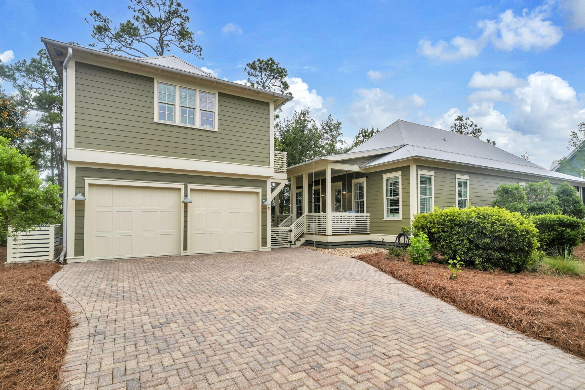 This coastal retreat boasts a single-story home, a 2-car garage, and a RARE separate Carriage House (one of only two in the community). This allows the ideal blend of comfort, privacy, and functionality. The detached carriage house provides exceptional flexibility for the homeowner. It features a full kitchen, living room with TV, and dining area, plus a dedicated office that would accommodate bunk beds. This carriage house also has a cozy private bedroom, and a well-appointed bathroom with heated floors and a rain shower. The 3-bedroom/21/2 bathroom main house features an open-concept kitchen, a spacious dining room, and living area designed for effortless entertaining and relaxed family gatherings. The roomy kitchen includes updated appliances, a wine and beverage center, and a large island with ample prep and seating space. Just off the kitchen is a conveniently located powder bath. A wide hallway leads to two generously sized guest bedrooms connected by a Jack-and-Jill bathroom with a double vanity and a tub/shower combination. Across the hall, the large private master suite features a walk-in closet with motion-sensor lighting and a spacious ensuite bath complete with double vanities and a large walk-in shower. Thoughtful details throughout the home include a large laundry closet with built-in drying racks for beach attire, a floor-to-ceiling storage closet, abundant attic storage, and an attached outdoor storage room perfect for bikes, beach chairs, and toys. Outdoor li Outdoor living is just as inviting, with two covered porches.  The screened in back porch has a swing bed for relaxing and book reading. Also on this porch, there is ample seating around a firepit. An enclosed outdoor shower makes rinsing off after beach days easy, while backyard lighting, gutters with decorative rain chains, security cameras, and a large driveway add both charm and convenience. One of the home's most desirable features is its peaceful setting. Tucked away on a cul-de-sac and backing up to a tree filled preserve at Topsail Hill State Park, the property offers exceptional privacy and natural beauty. Just steps away is the community's scenic 100+ year-old Cypress Pond, complete with a picturesque boardwalk and benches for enjoying wildlife and tranquil afternoons. Located within the gated Cypress Dunes community, residents enjoy resort-style amenities including two pools--one with an infinity edge overlooking Topsail Hill State Park and Preserve and the Gulf. A bubbly hot tub is near the main pool. At the smaller pool, you can enjoy the sounds of water flowing over the edge of the water feature. Amenities also include tennis and pickleball courts, a fitness center, a clubhouse, a fireplace lounge, and scenic walking boardwalks throughout the neighborhood. Best of all, Cypress Dunes is less than one mile from the sugar-white sands and emerald waters of the Emerald Coast's beautiful beaches.