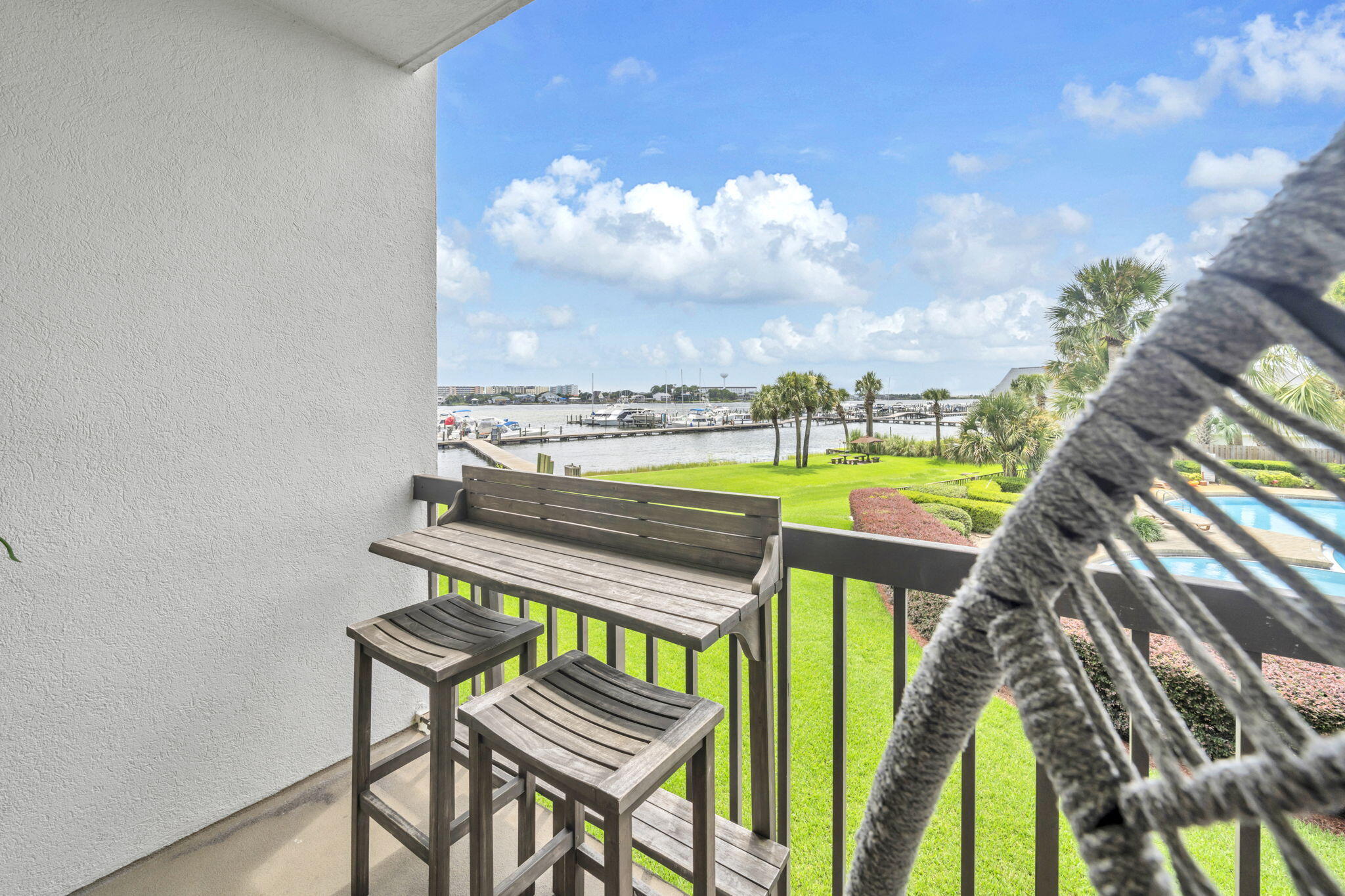 Imagine owning a turnkey vacation getaway...that comes with your very own boat slip! Santa Rosa Sound Access +  Slip is 39'length/max allowed 36' Boat - Ready for Rental Income! This beautifully styled, fully furnished studio features warm coastal décor, modern finishes, and wood-look laminate flooring for an upscale beach vibe. The remodeled kitchenette includes an induction stovetop and Apt-size fridge--perfect for guests or weekend getaways. Step onto the balcony and unwind at the bar-height dining set while enjoying tranquil pool views--ideal morning to evening. Access Santa Rosa Sound via the private beach area for kayaking or paddleboarding. The 36' boat slip can be rented short or long term. See Marina Rules.  Deep soaking tub with cultured marble surround. New A/C (2024).