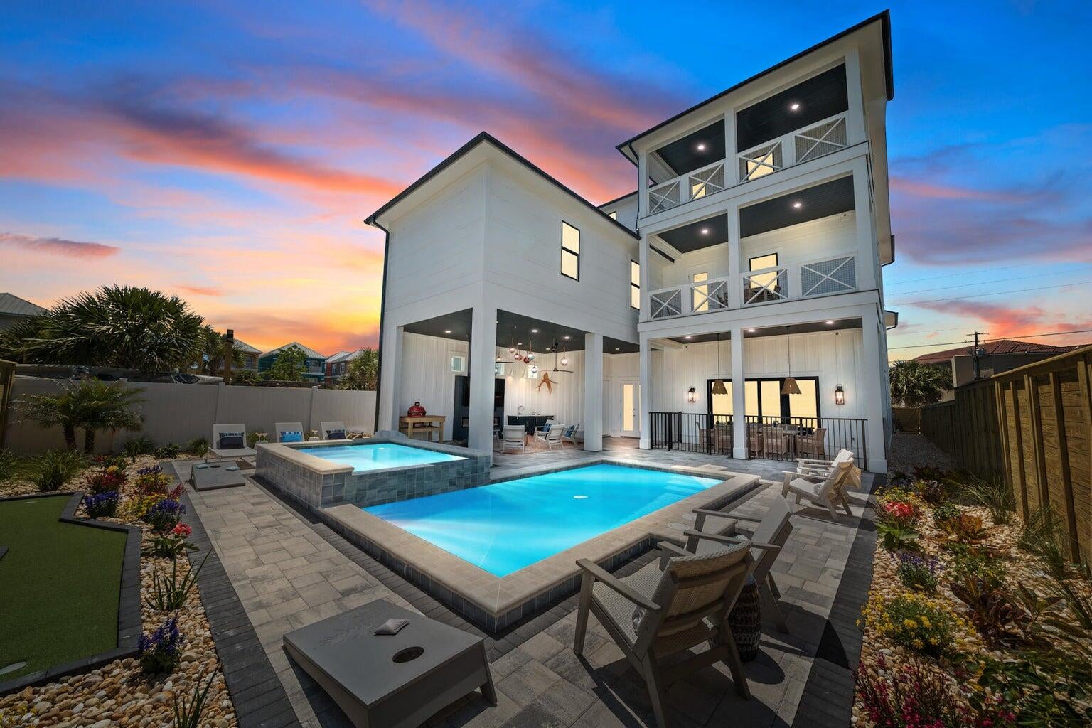 'Colors are the smiles of nature' and this vibrant beach home brings that sentiment to life in every corner. A thoughtful blend of hues flows throughout the property, creating a warm, garden-like atmosphere where each room features its own unique palette designed to both energize and relax. This custom-designed residence maximizes every inch of space, transforming each nook into a functional and inviting area. With nine bedrooms and accommodations for up to 21 guests, the home offers exceptional space and comfort, allowing everyone to spread out and enjoy their own retreat. All three floors feature bedrooms, full bathrooms, and inviting spaces for gathering or unwinding. The kitchen and main living areas are tucked toward the rear of the home, creating a central hub for connection and