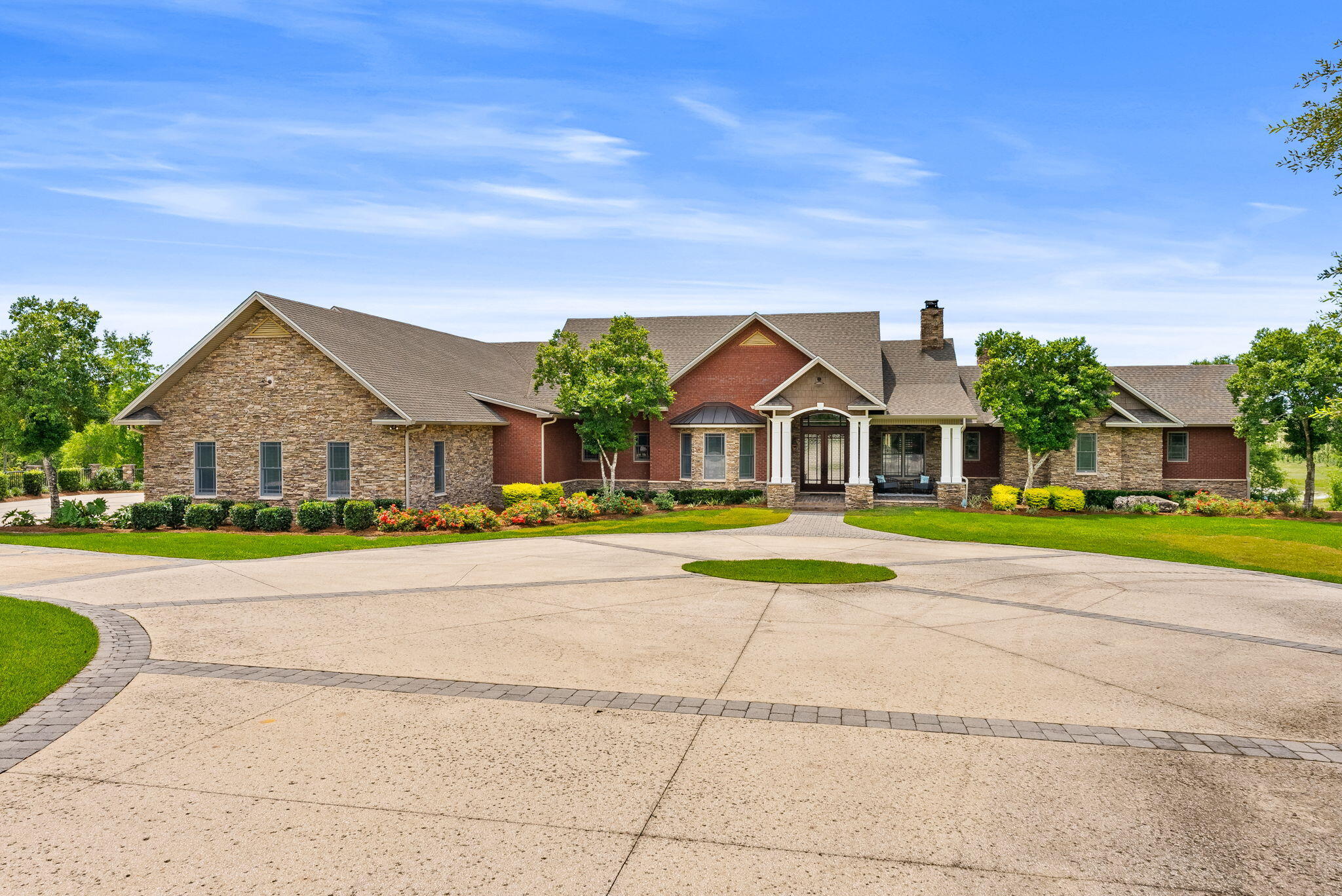 Rare Offering: 100-Acre Private Estate | Equestrian Friendly | Owner Financing Available
Welcome to 2601 Highway 20 E, a once-in-a-lifetime opportunity to own a breathtaking private estate in Panama City, Florida. Equestrian friendly and set behind a grand 14-foot private gate surrounded by over 45 acres, a 60 x 100 outdoor building (6,000 square feet), 7-stall barn with tack room and bathroom, all new planted pines in 2023, and a private spring-fed lake, this custom-built home offers the perfect balance of luxury, functionality, and country living.
Built in 2007 by renowned builder Rita Jones, with quality and craftsmanship at its core, this expansive 6-bedroom, 6 full bath, 2 half bath estate boasts over 7,351 square feet of heated and cooled living space. From the moment you step inside, you are welcomed by soaring vaulted ceilings, large open spaces, and refinished hardwood floors. Thoughtfully designed finishes are found throughout. The first floor is constructed with solid concrete block for strength and longevity, while the second floor features durable 2x6 framing for added efficiency and durability.
The spacious primary suite is a true retreat, featuring his and her closets, a spa-like bath with custom tile shower, heated floors in bathroom, and a Toto toilet. Peaceful views of the surrounding property complete the experience. Entertain with ease in the formal dining room or game room, host unforgettable gatherings around the outdoor kitchen, or retreat to the cozy study for a quiet evening. The gourmet kitchen and luxurious living areas flow seamlessly to the outdoors, where a zero-entry saltwater pool, lush landscaping, and breathtaking lake views await.
The home is equipped with a Control 4 Smart Home system, spray foam insulation in the walls and ceilings, Andersen storm doors and windows, and four HVAC units for maximum energy efficiency. For convenience and peace of mind, the property features two 200-amp electrical panels, two deep wells, two septic systems, and a 40KW whole-house generator powered by a dedicated 500-gallon propane tank, with a separate 500-gallon propane tank serving the home.
The estate also includes a three-car garage with insulated 12' x 10' doors, offering plenty of space for vehicles, recreational toys, or additional storage. At the heart of the property lies a serene spring-fed lake teeming with bass, bream, and catfish -- the perfect backdrop for fishing, paddling, or simply relaxing in the beauty of nature.
This is more than a home -- it's a lifestyle. A place where wide-open spaces meet modern comforts, where equestrian dreams come to life, and where every day feels like a retreat. Located just minutes from Panama City and Lynn Haven, and only 17 miles from the world's most beautiful beaches.