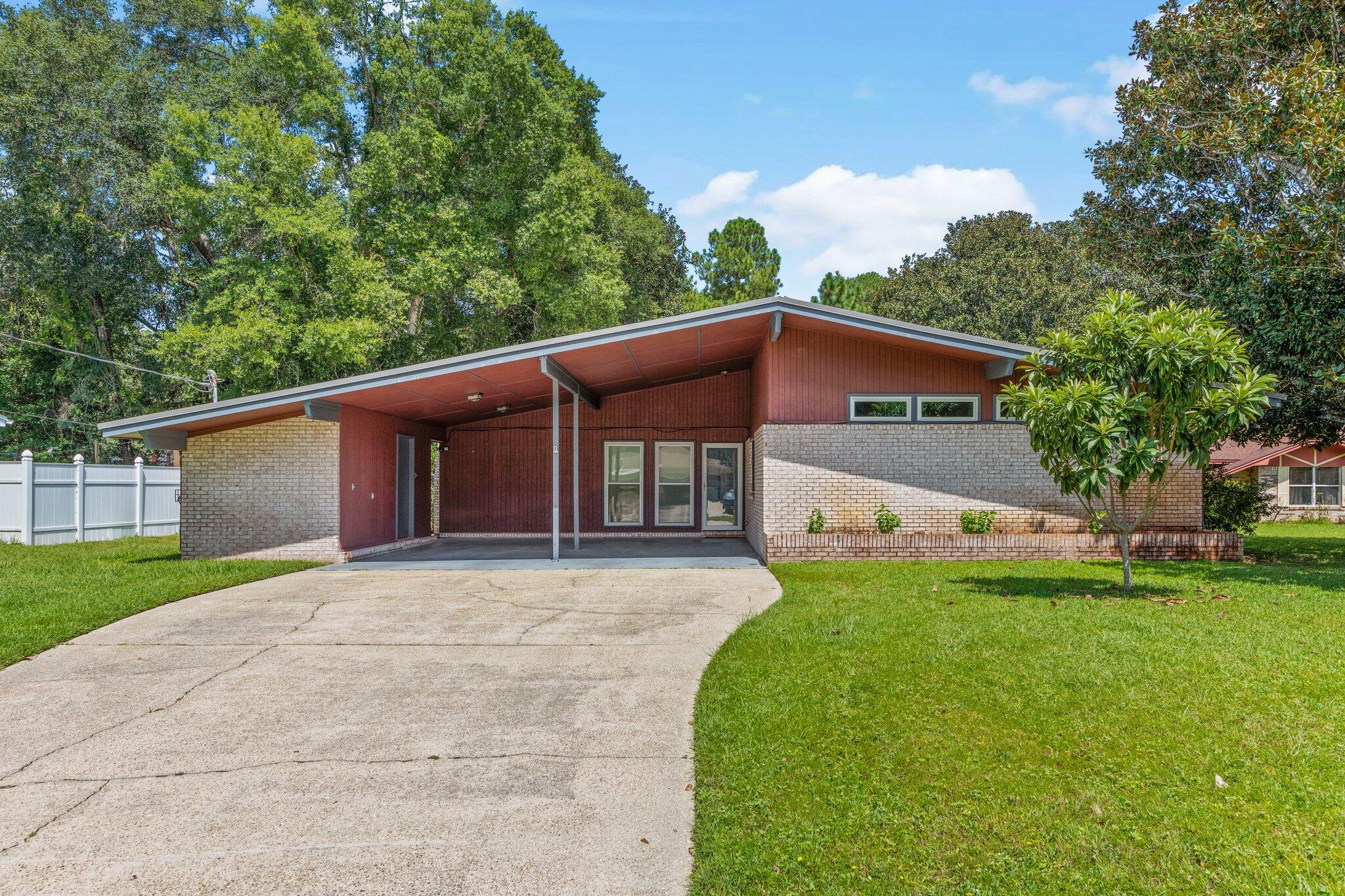 This beautifully updated mid-century modern home blends timeless character with modern features. Warm, inviting, and filled with natural light, this one-of-a-kind property offers a perfect balance of charm and comfort. Picture gathering with friends in the spacious great room, unwinding in the stylishly renovated primary bath with a sleek tiled shower, or enjoying your favorite drink from the comfort of your screened porch as the sun sets.

Situated in the heart of Niceville, the home is conveniently close to top-rated schools, shopping, dining, and offers easy access to Destin, Fort Walton Beach, and Eglin Air Force Base, along with major routes connecting you across Northwest Florida.

Inside, you'll find a bright and airy living space with high ceilings and an abundance of natural light. The open-concept design flows effortlessly into an inviting eat-in kitchen, ideal for entertaining. A spacious den provides additional room to relax or host guests.

There is separate storge/laundry room that is big enough to store your outdoor belongings within.

Enjoy peaceful mornings in the generous Florida room and take advantage of the large backyard--perfect for outdoor living and entertaining. Schedule your showing today and experience everything this exceptional home has to offer!