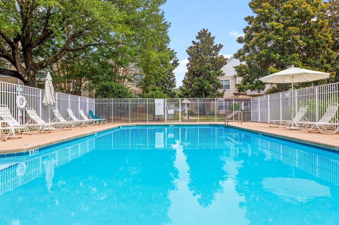 Second-floor unit in The Oaks featuring an included washer and dryer for added convenience. The kitchen is tucked away from the main living room, featuring a 4-stove gas burner and bar stool area. The primary bedroom offers a private en suite bath with a tub/shower combination, while the hall bathroom features an easy step-in shower. Residents can enjoy community amenities including the pool, gazebos, and BBQ grilling areas. Perfect for relaxing and entertaining. Contact us today to schedule a showing!