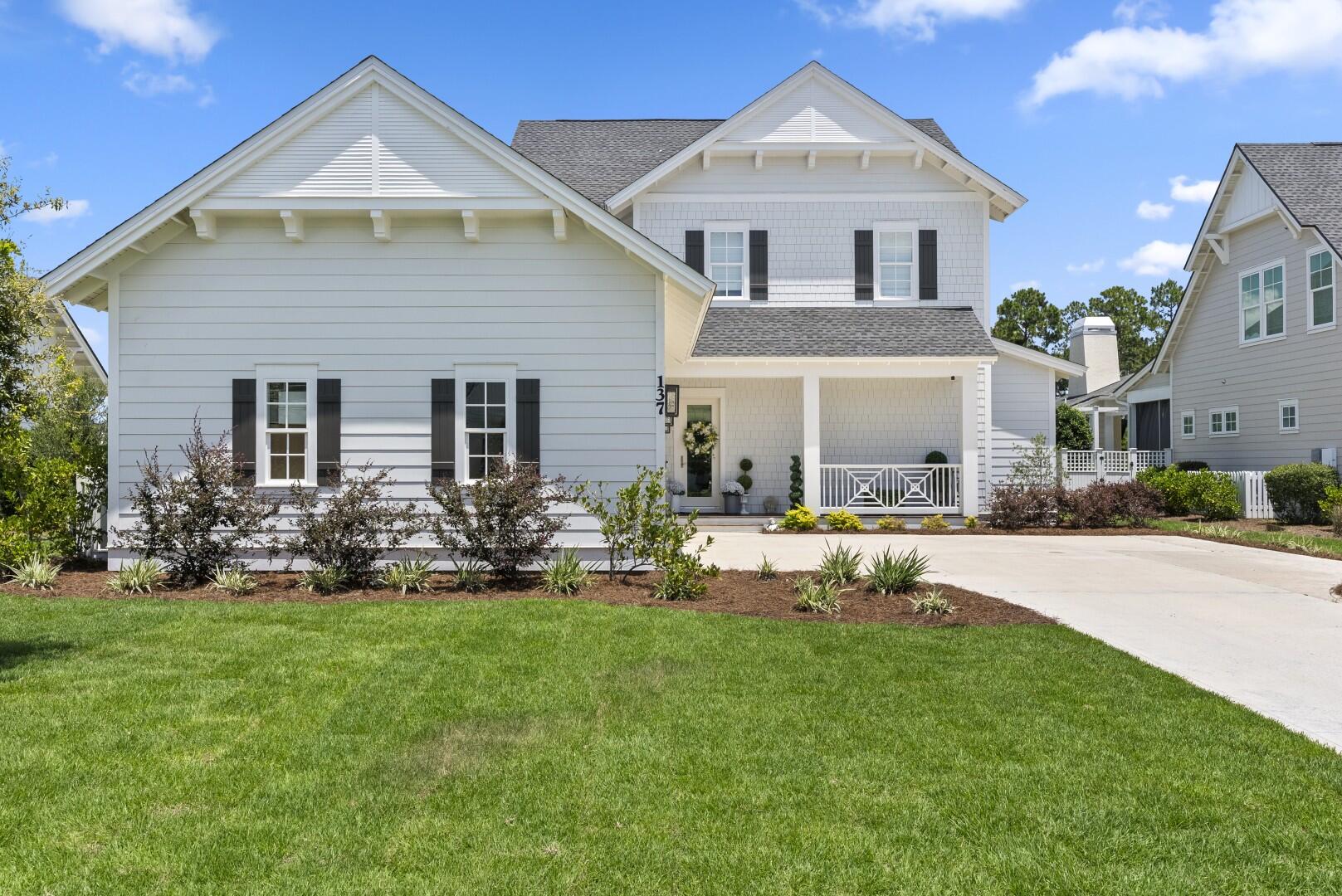 4-BEDROOM, 4.5-BATH CUSTOM HOME | 3,293 SQ. FT. HEATED & COOLED | 1,416 SQ. FT. OF COVERED OUTDOOR LIVING | PREMIUM WATER LOT - 137 Needle Cast Lane is a custom home located on a quiet cul-de-sac in WaterSound Origins, positioned on a premium water lot with views of the surrounding natural landscape. The home offers two (2) master bedroom suites, one on each level, along with six outdoor living spaces providing an additional 1,416 square feet of covered outdoor living featuring Cumaru decking. The outdoor areas include two screened-in porches, sun and shade deck areas, and multiple spaces for outdoor dining, entertaining, relaxing, or enjoying the water views and surrounding wildlife, including deer. Inside, the 3,293-square-foot residence features an open floor plan with 10-foot ceilings, hardwood flooring throughout, and connected living, kitchen, and dining areas. The kitchen includes professional-grade stainless-steel appliances and finishes from Thermador, Bosch, and Grohe. The first floor includes a spacious living and dining area, kitchen, one of the two master suites, a powder room, and access to the outdoor living areas. The second-floor master suite overlooks the water and includes a private bath with dual vanities, garden tub, separate shower, and large walk-in closet. Two additional guest bedrooms and two full bathrooms are located upstairs, along with an oversized loft area and outdoor balcony. Seller is a licensed Real Estate Agent.