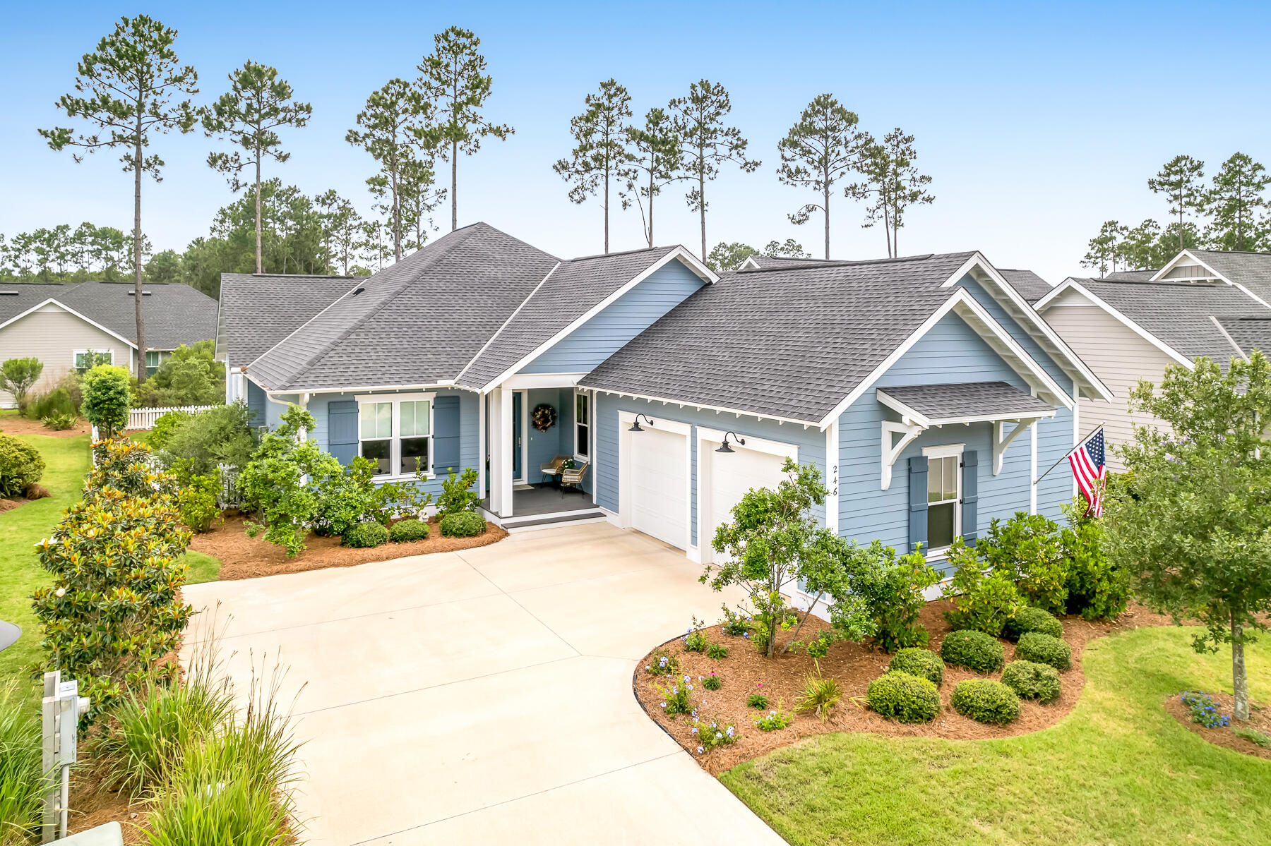 Offering the appeal of like-new construction without the inconvenience of nearby building activity, this lovely, light-filled and meticulously maintained residence is located within the charming and conveniently located Pathways neighborhood of Watersound Origins. Perfectly positioned on a quiet, non-through street, the home backs to a well-maintained common area with mature trees and landscaping, creating a private and peaceful setting. This comprehensive floor plan features ten-foot ceilings, solid-core interior doors, wood floors throughout, four bedrooms with generous closets, and three full baths. The enchanting, private and fully fenced backyard with expanded paver patio, grilling area and beautiful mature landscaping creates an exceptional outdoor entertaining retreat with ample space for a future cocktail pool. The open floor plan showcases the dining room, a large chef's kitchen complete with quartz counters, custom cabinetry with additional drawer space, capacious pantry and a bar area. The adjoining spacious living room is enhanced with a striking gas fireplace featuring remote-control operation. The generous, light-filled primary bedroom offers a lovely spa-like bath and large closet with custom built-ins, sure to impress. The oversized garage has been improved with epoxy floors, extensive built-in cabinetry, a dedicated workspace and utility sink, offering both exceptional functionality and storage. The home is wired for a two-zone whole-home sound system, including the rear porch.The Watersound Origins community offers a blend of modern convenience and outdoor recreation. Residents have access to a plethora of amenities including the Village Commons featuring a resort-style swimming pool, an events lawn, a fitness center, and sports courts. The community boasts parks, miles of scenic walking and biking trails, and Lake Powell access for residents' enjoyment. 246 Trailhead's desirable location places two neighborhood parks nearby, offers a short stroll along the community path to Village Commons, and is just 1.2 miles from Publix and the growing Watersound Town Center. Adding to its appeal, the Watersound Origins enclave hosts the esteemed Origins Golf Club, with a 10-hole, par-3 Davis Love designed course. Additionally, the burgeoning town center at the neighborhood's entrance features a Publix grocery store, multiple dining options, retail stores, and various essential services. This coveted neighborhood does not allow short-term rentals, further enhancing its peaceful residential character.