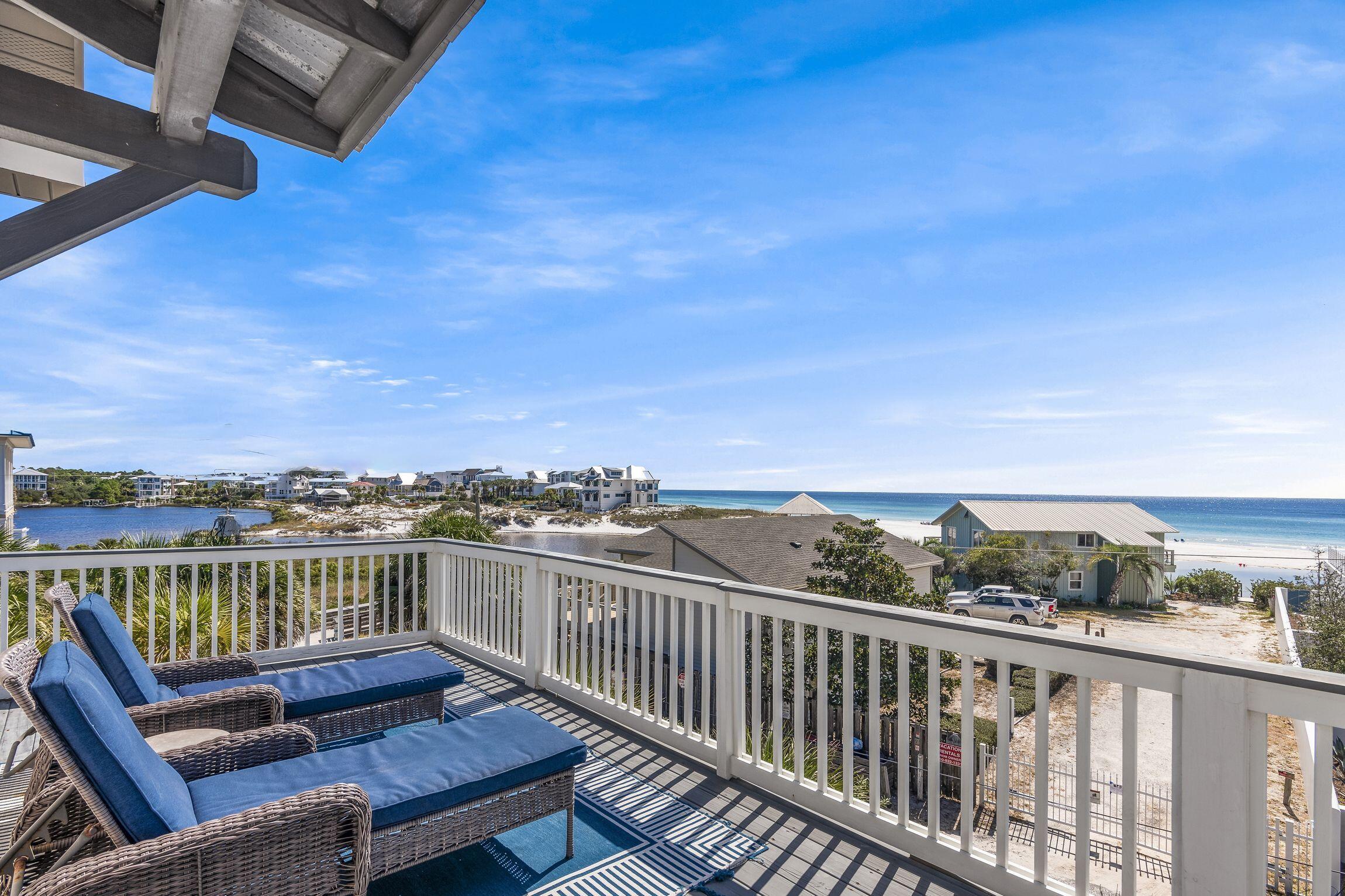 Set squarely in the heart of Seagrove Beach, this seven-bedroom retreat has been thoughtfully reimagined and expanded into a multi-generational getaway framed by sweeping gulf and lake views. The transformation is evident throughout, pairing a well-considered floor plan with an easy, harmonious coastal palette -- the kind of luxury that never announces itself, contemporary, unhurried, and effortlessly livable. Across three levels, the home gives everyone room to spread out. The ground floor features a private lock-off with three guest bedrooms, a living room, and a brand-new kitchenette anchored by a quartz-topped dining island. It's a self-contained retreat with direct ground-floor access and a shaded porch made for slow alfresco mornings. Hardwood floors and shiplap walls echo the landscape just beyond the door, while multiple covered porches and an outdoor shower encourage easy outdoor living. The second floor is where the home comes together. The main living and dining spaces flow seamlessly onto an expansive wraparound deck, while floor-to-ceiling windows and sliding glass doors frame views of the Gulf of Mexico and the untouched expanse of Eastern Lake. The kitchen is built for a full house, with quartz countertops, a fresh tile backsplash, KitchenAid appliances, and ample space to gather. This level also includes a charming bunk room, an additional guest bedroom, and a full bath conveniently located off the living area. The third floor serves as a private retreat, featuring the primary suite and an additional guest bedroom, both with ensuite baths, along with a conveniently located laundry area. At the top of the home, two handsome guest suites open onto an upper balcony where gulf and lake views stretch uninterrupted from first light to last. It's a home designed for the rhythm of a large gathering -- coming together for meals and conversation, then retreating to a private corner of one's own. There's generous storage for beach gear and a private rear yard with an outdoor shower for rinsing off the day. The water is closer than you'd think, just 12 steps from public beach access for a sunrise swim or an evening walk along the white sand. For the more adventurous, the rare coastal dune lake nearby offers opportunities for kayaking, paddleboarding, fishing, and exploring a stretch of shoreline that remains genuinely unspoiled. When the sun goes down, Seaside, Florida, Watersound, and Rosemary and Alys Beaches are all within easy reach, each offering its own blend of dining, boutique shopping, and entertainment.