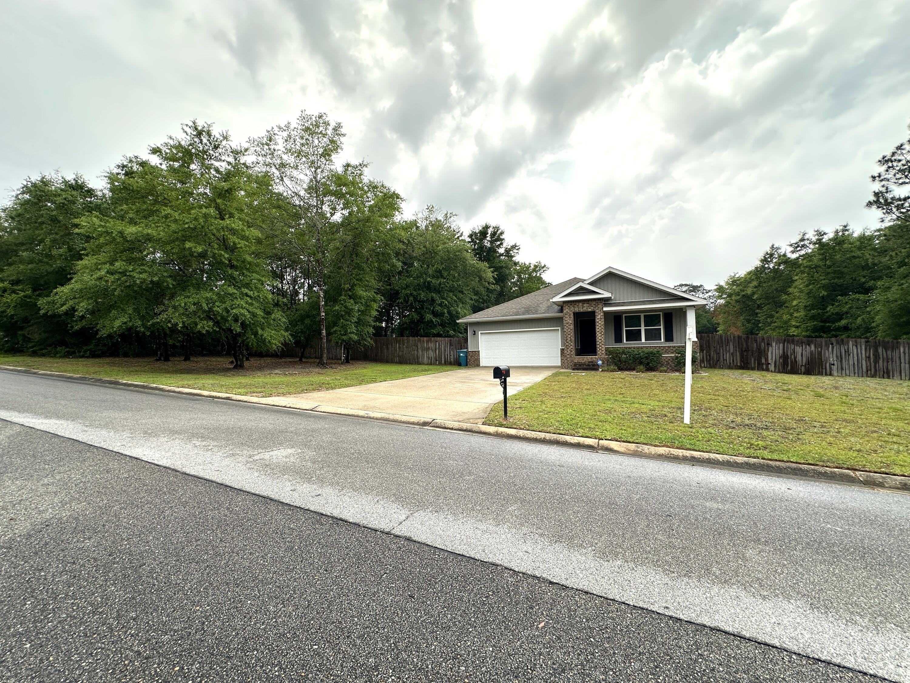 Come see this wonderful home about 5 miles north of Crestview. Just far enough from town, but not quite in the country! It's located in a nice neighborhood, with spacious lots and charming homes. This home is situated on .60 acres, and the backyard is fully privacy fenced. This open floor plan features great sight lines for the main living area, kitchen and dining room -all open to a beautiful kitchen with white cabinets, a huge center island with breakfast bar, stainless steel appliances and a pantry. The master bath features a large walk-in shower, double vanities, water closet and 2 closet spaces. There are so many possibilities for the yard space here, so feel free to let your outdoor living dreams expand! This home is priced to sell, so call to see itASAP!