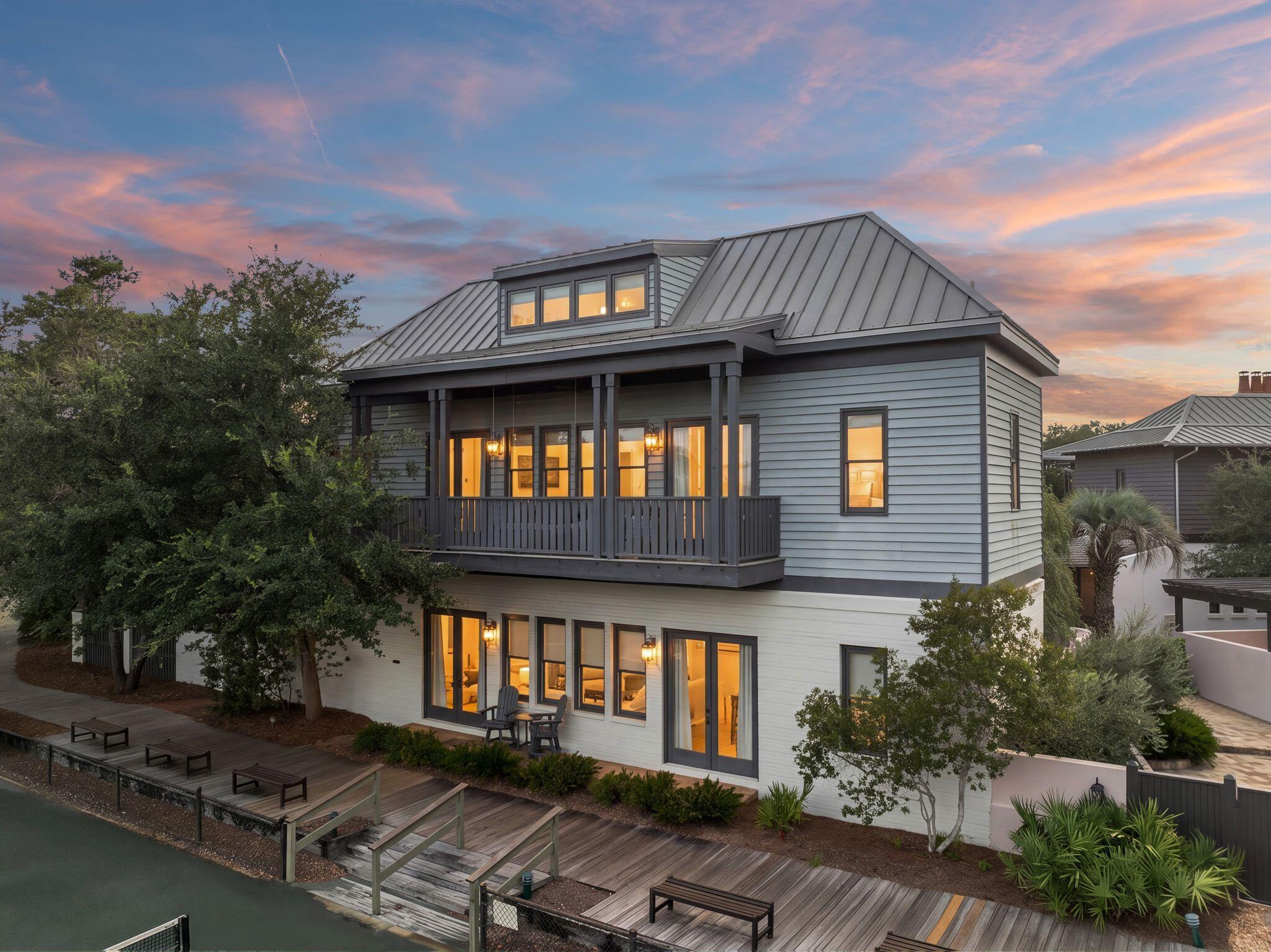 23 Turks Lane is a 5-bedroom, 5-bath home with a loft and separate carriage house, positioned along a main Rosemary Beach boardwalk and overlooking the tennis courts. The oversized lot includes a charming brick courtyard with outdoor space serving both the main house and carriage house.

The main house opens from the courtyard into the kitchen and dining area through 10-foot doors. Brick accents, granite countertops, stainless-steel appliances, and 11-foot ceilings carry throughout the main living spaces. A first-floor bedroom and bath are complemented by two additional bedrooms upstairs, including a primary suite with a private bath and Balcony. The third-floor loft includes four twin beds and an additional large bath and play area. 

The separate 2 story carriage house offers additional space for guests or family, along with the convenience of a 2-car garage. The home is also close to one of Rosemary Beach's pools, Fitness Center, Eastern Green, and the beach.

23 Turks Lane offers a unique combination of space and prime location within the Rosemary Beach community.