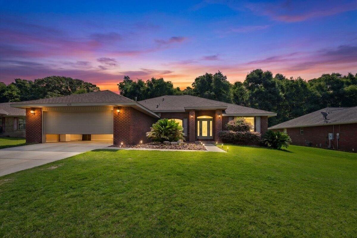 OPEN HOUSE SATURDAY JULY 11, 10AM-12PM!! Step into this beautifully updated home featuring an open-concept layout designed for both everyday living and entertaining! Gorgeous luxury vinyl flooring flows through the home, complemented by tasteful designer-inspired colors that create a warm, modern feel. The stylish kitchen is a standout with quartz countertops, gorgeous glass backsplash, newer gas stove, and a fabulous breakfast bar with pendant lighting perfect for serving meals with ease. The spacious great room offers a stunning floor-to-ceiling stone fireplace that instantly catches your eye. One of the true highlights is the huge high-quality brick Florida sunroom addition complete with ceiling fan, offering incredible flexibility for relaxing, dining, or creating the perfect play area. The beautifully updated bathrooms feel straight out of a spa retreat. The spacious primary suite features a trey ceiling, stylish fan, separate closets, and private access to the Florida room for peaceful mornings overlooking the trees. This home truly shows like a dream -- get here fast before someone else makes it theirs! BRAND NEW ROOF