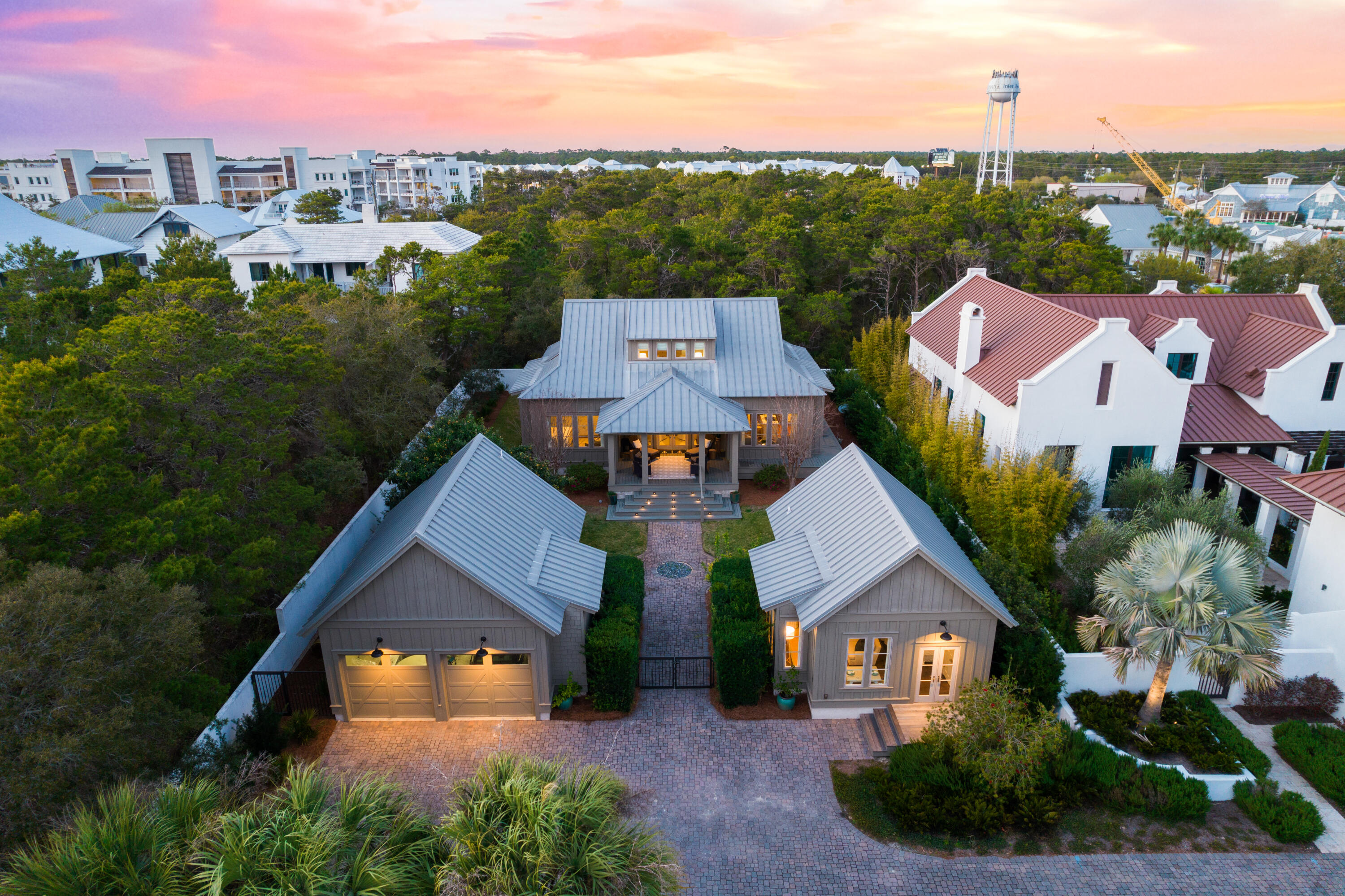 Perfectly positioned within feet of the white sugar sand and emerald hued 30A waters, this charming residence encompasses nearly three thousand square feet of strategically planned living space on an oversized private homesite in the heart of Inlet Beach. Open to the sky above, the welcoming courtyard leads the way to grand front entrance and deep front porch.

Designed with entertaining in mind, the interconnected living areas are anchored by the gourmet kitchen featuring custom cabinetry, a fully equipped wet bar, and a luxury appliance suite. The stunning hardwood floors and  wooden accents contrast with the crisp white palette to curate the modern costal flair carried throughout. Showcasing the surrounding tree line and lush vegetation, the window lined main suite boasts direct porch access and a sumptuous main suite with a dual vanity, tiled shower, and ample storage.

An additional bedroom and laundry area complete the first level. A secondary main suite, bedroom, and flex space currently configured as a play room is found on the second level. Fully self-sufficient, the detached guest quarters located adjacent to the two car garage incorporates a living area, sleeping quarters, kitchen, and bathroom suite.

Bordered by thirteen acres of protected dunes, Inlet Beach remains one of the most sought after beach communities affording residents with a quaint coastal town flair while remaining geographically poised minutes from the iconic town center of Rosemary Beach in addition to all of the world class dining and entertainment venues 30A has to offer. Offering a culmination of unique and desirable amenities, 296 Walton Rose Lane creates a compelling opportunity for investors and full time residents alike. Inquire today to arrange a private viewing and start envisioning the coastal lifestyle you deserve.