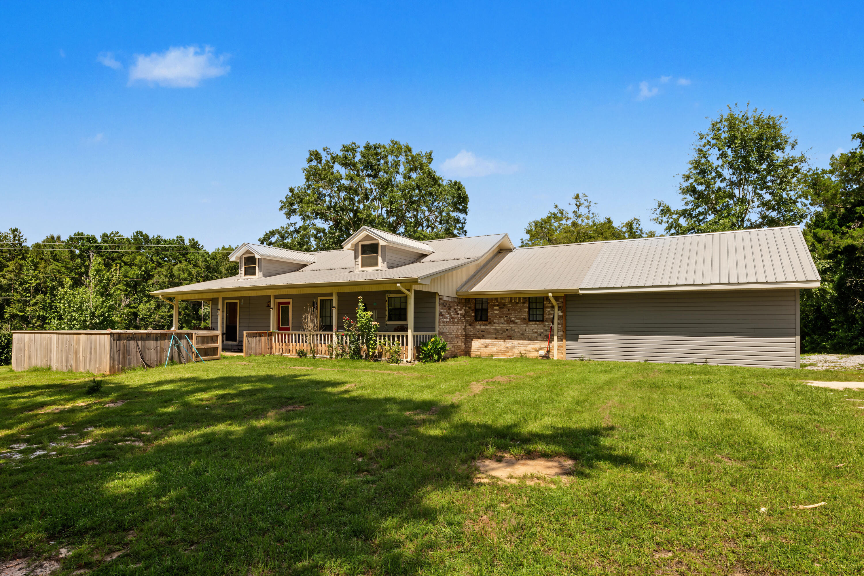 Welcome to country living at its finest! If you've been searching for the perfect blend of peaceful surroundings, usable land, and endless potential, this incredible property is ready to make your dreams a reality. Nestled on approximately 9 beautiful acres, this one-of-a-kind property offers the ideal setting for horse enthusiasts, hobby farmers, outdoor lovers, or anyone looking to enjoy the privacy and freedom that only country living can provide.

The true centerpiece of this property is the impressive 32' x 60' barn, complete with horse stalls and ample space for equipment, hay storage, or additional livestock. Whether you're an experienced equestrian or simply looking for room to grow, you'll appreciate the functionality and versatility this barn provides. In addition, the property features a detached garage/workshop with an attached covered carport, making it perfect for mechanics, woodworkers, small business owners, or anyone needing extra storage for vehicles, boats, tractors, or recreational equipment.

The home offers a comfortable 3-bedroom, 2-bath split floor plan designed with both privacy and functionality in mind. The spacious family room is perfect for those gathering with family and friends with an access to the oversized back porch. Enjoy the gorgeous sunsets and sunrises on the front porch or the oversized back deck. A must see!!! Minutes to the Vortex Springs - This popular destination offers scuba diving in natural caverns. The underwater experience is thrilling, making it perfect for divers of all skill levels. You can dive deep into the clear blue waters, filled with vibrant fish and fascinating rock formations.