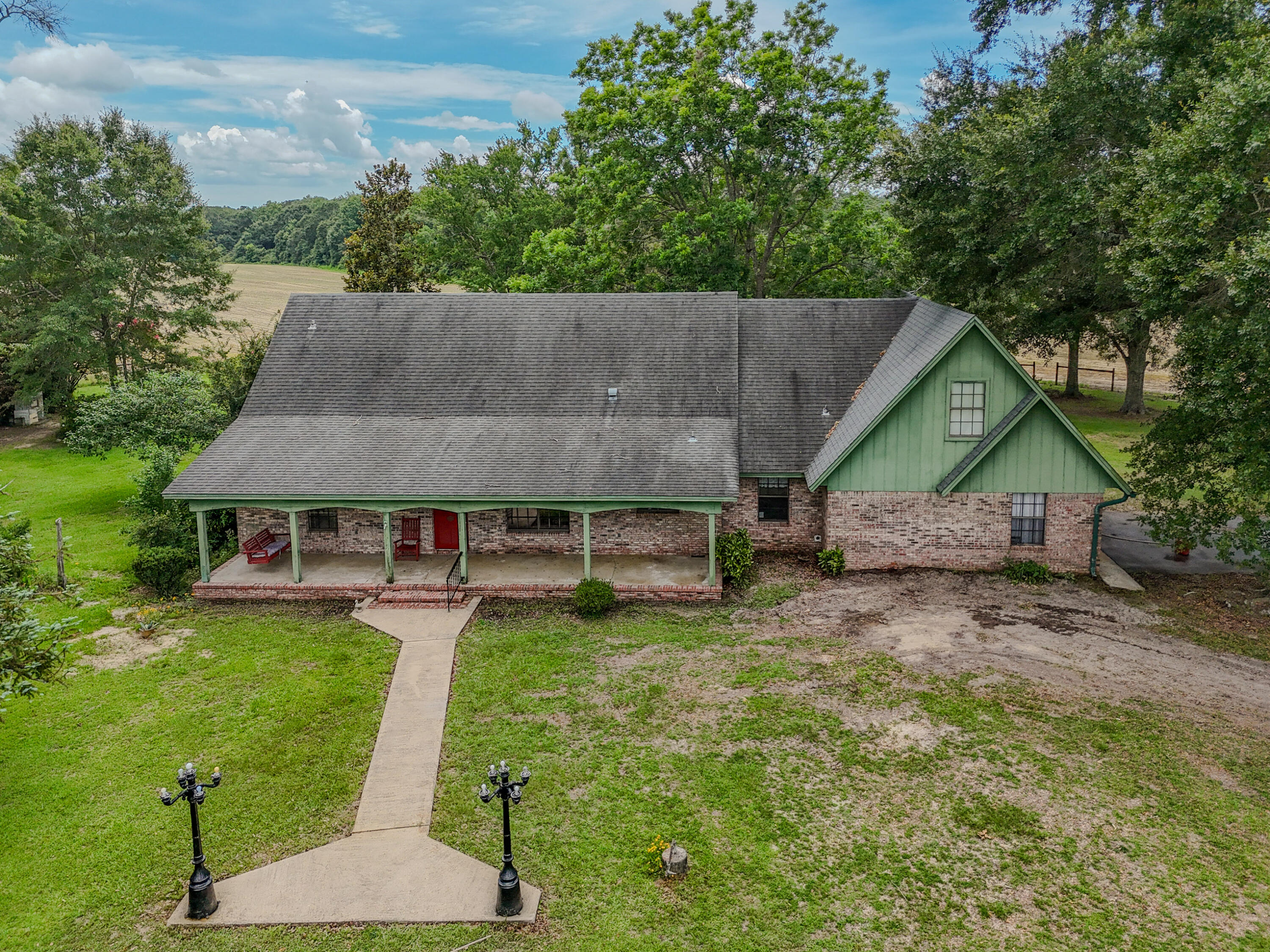 EXECPTIONAL 156.22-acre property offering country living, recreation, and income potential. This spacious 2200+ sqft home features a large welcoming front porch, great living room with a fireplace, a large kitchen that has tons of cabinets with a connecting laundry and pantry/storage area. Home also includes a formal dining, large master suite, split floor plan and tons of storage. Afternoons can be enjoyed as well on the large covered back porch overlooking the pastures. A large bonus room above the garage offers endless possibilities for a game room, home office, guest space, or can be used as additional living area. Property offers a beautiful 5-acre stocked pond for fishing and enjoying peaceful waterfront days. Property includes pear trees, blueberry bushes, fig trees, and mature pecan trees. Three large crop fields provide excellent farming. Wildlife is abundant, making this an outstanding property for hunting as well. Whether you're seeking a working farm, recreational retreat, hunting property, or private homestead, this acreage and home offers everything you are looking for in a country homestead. Enjoy the privacy of rural living while taking advantage of productive land, established fruit and nut trees, excellent fishing, and abundant wildlife. Rare opportunity to own a property with spacious living, agricultural land, and year-round outdoor recreation. This property is located on a paved road and is just North of Crestview making running to town easy!