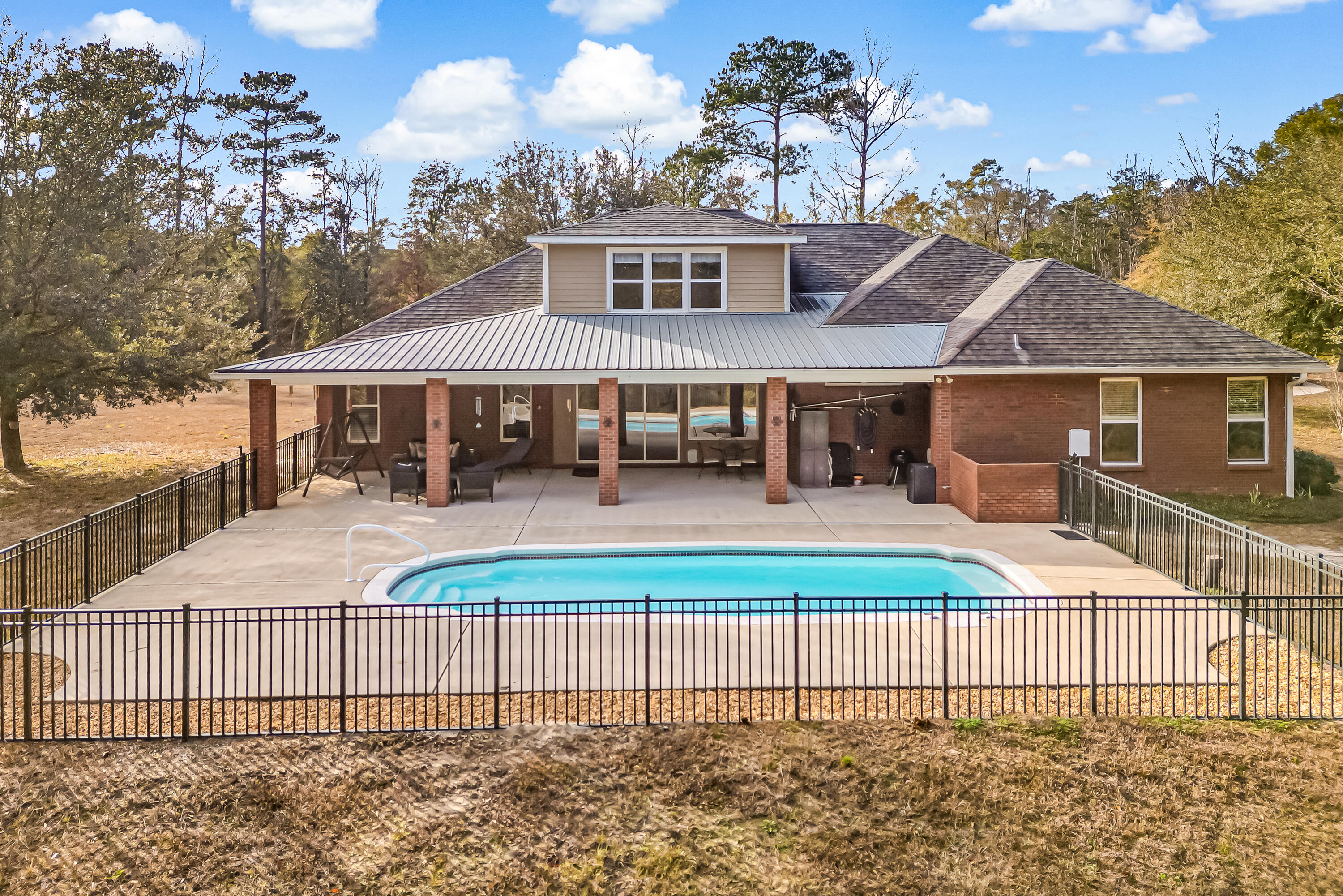 BACK ON MARKET due to no fault of the seller--buyer financing fell through, and the home has already appraised at asking price! Your second chance is here!

This custom-built estate offers exceptional craftsmanship, thoughtful design, and rare versatility. The grand entryway leads to a formal dining room and a dedicated office, flowing into a kitchen with custom maple cabinetry, granite countertops, and breakfast bar. Perfect for entertaining, the kitchen overlooks the spacious family room, sunlit Florida room, and your own sparkling saltwater pool oasis. The smart split-floor plan prioritizes privacy. One wing features three spacious bedrooms, while the opposite side boasts a luxurious owner's suite and a private. Upstairs, a versatile 5th bedroom offers endless possibilities. Vehicle and hobby storage is unmatched with a large driveway, attached  and a detached 2-car garage. Bring your horses or start a mini-farm--this incredible acreage provides endless space for barns, riding trails, and outdoor freedom! Enjoy the peace and privacy of no neighbors, nestled on 16+ private acres, this home provides the perfect blend of country living and convenience, just 5 minutes from DeFuniak Springs.  The best of both worlds. space, style, and serenity.