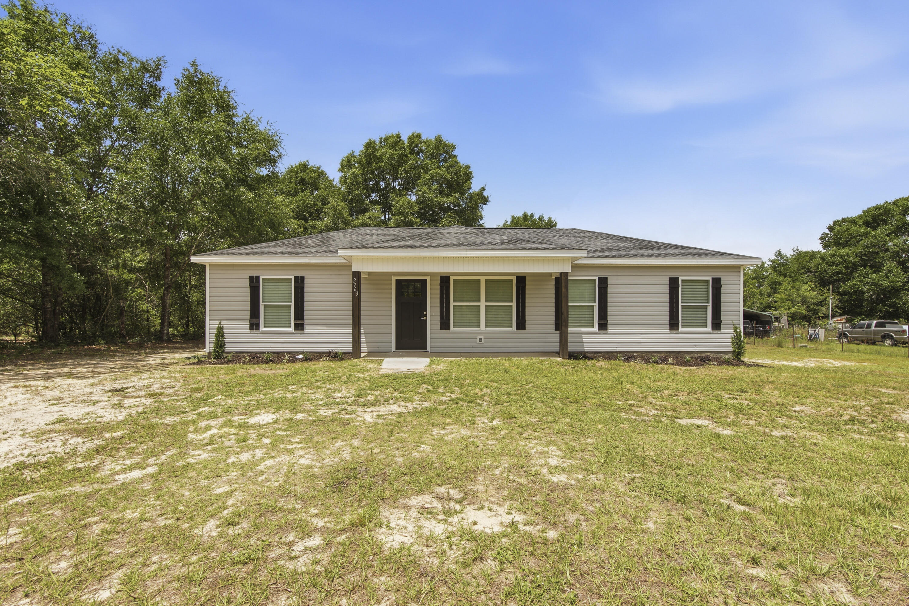 Welcome to 2763 Oak Ridge Road where wide open skies meet everyday comfort.  Nestles on nearly an acre of land in the heart of the Florida panhandle, this well built 2008 home offers four bedrooms with a split floor plan, two full baths across 1200 square feet of easy, efficient living.
The .78 acre lot gives you room to breathe, garden, add outbuildings, or simply enjoy the quiet of country life while staying connected to everything DeFuniak Springs has to offer, a charming historic downtown, local dining, easy I-10 access, and less than an hour's drive to the sugar white sands of the Emerald Coast.
What truly sets this property apart is the metal hangar, a rare and highly versatile structure perfect for hobbyists, contractors, or anyone needing serious workspace.  Whether you are using it for  a boat, a small RV, equipment, or running a home based business, this is the kind of bonus you don't just find at this price point.
All kitchen appliances and washer/dryer convey.
PLEASE SEE QUESTIONS AND ANSWERS DOCUMENT. This home has completely been remodelled.
