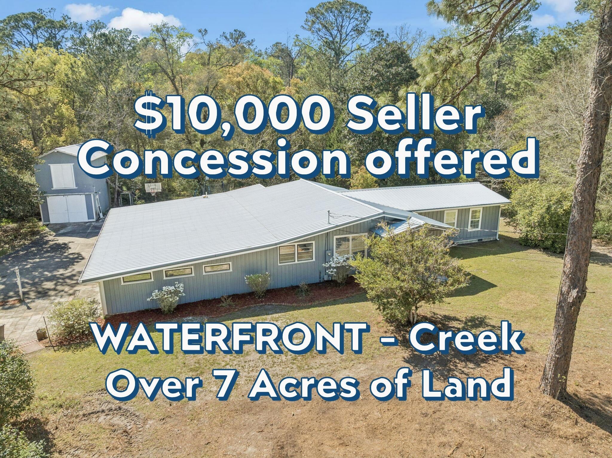 *$10,000 seller concession offered with a full price offer* Welcome home to charm, space, and a touch of nature just 2 blocks from the beauty of Lake DeFuniak!
This 3 bedroom, 2.5 bath home offers oversized bedrooms and a thoughtfully designed layout with both comfort and functionality in mind. It is located on approximately 7.2 acres with a creek running through. The spacious primary suite features brand-new carpet, direct access to a private back deck through sliding glass doors, and a beautifully updated ensuite with a custom walk-in shower and double vanity. An added bonus: the large laundry room is conveniently located right inside the primary walk-in closet. Throughout the home, you'll find a blend of character and updates, including original hardwood flooring in select rooms and a welcoming formal dining area complete with a wood-burning fireplace (currently capped, but full of potential). The kitchen is well-equipped with real wood cabinetry, stainless steel appliances, a double oven, and a breakfast bar. There is also a large pantry/storage area. Off the double carport you will find the half bath, a storage room and another space currently being used as a home office. Enjoy the outdoors with frequent deer sightings, a brick-paver patio, a creek flowing through the property and a large two-story barn perfect for storage, hobbies, or future possibilities. This home is situated perfectly if you are one to enjoy your own quiet space with plenty of room to roam and also be close to town. It's a short distance to Lake DeFuniak as well as DeFuniak Springs Main Street Downtown area for dining and shopping options, among more! This home has been beautifully maintained and updated. Contact your favorite realtor to schedule a showing. Appointment only.
