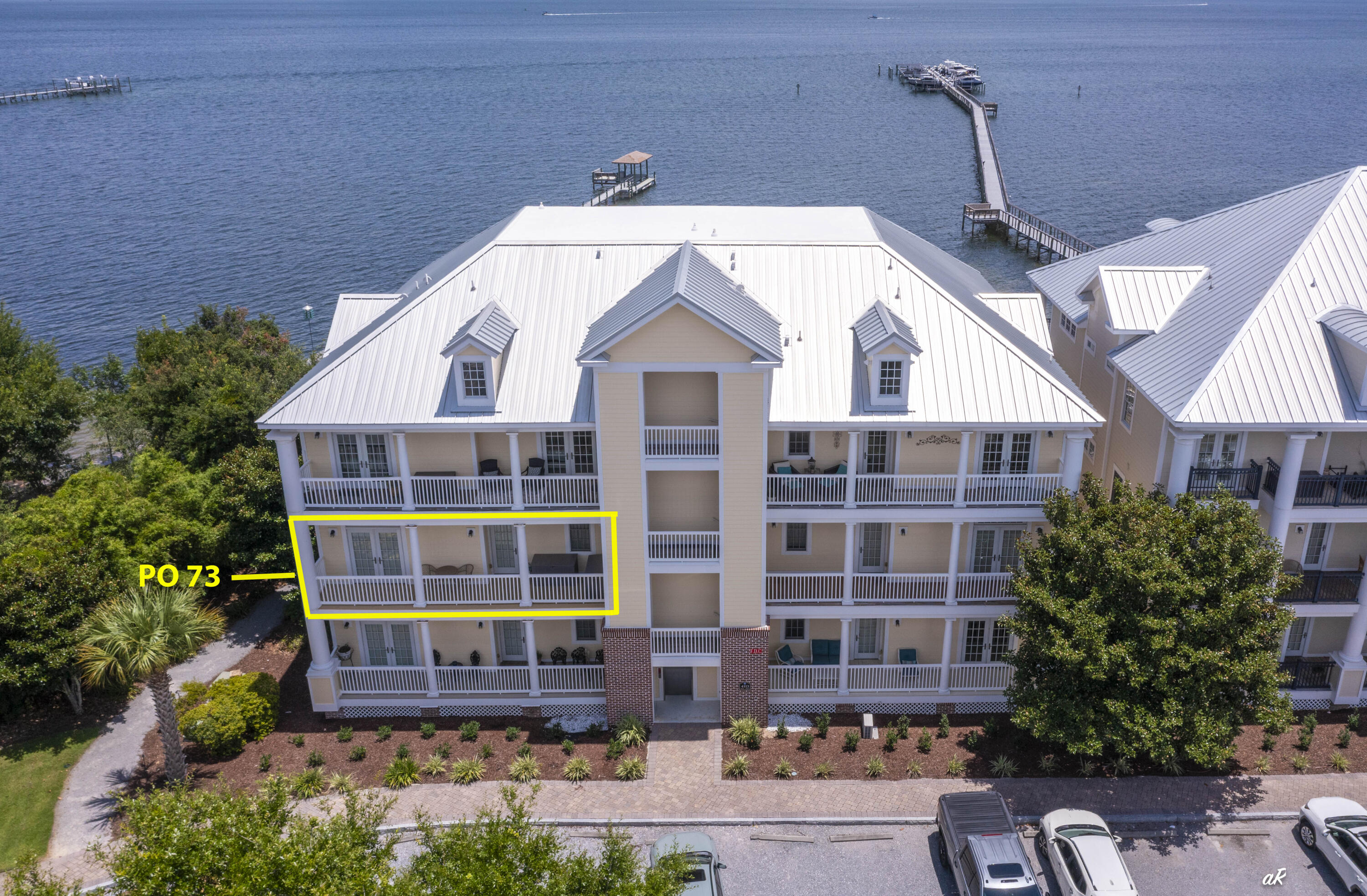 This extraordinary waterfront end unit condo, nestled in the exclusive gated Waterhaven community, right on St. Andrew's Bay, is a true haven! Meticulously maintained, this spacious one level floor plan, with its rich hardwood flooring throughout the main areas, stunning granite countertops, exquisite cabinetry, a gas range, and a kitchen island perfect for entertaining large groups, is a dream come true! Let's not forget that breathtaking view, which can be enjoyed from the kitchen, living and dining areas, along with the Master Bedroom! Now, can you envision yourself sitting on your expansive deck, sipping your morning coffee, watching the sun rise over the water, and being greeted by dolphins? Or strolling along the community dock and being whisked away by boat for a five-minute ride to Shell Island? Better yet, having the luxury of choosing between lounging by the Bay front (seasonally heated) pool or the Bay front beach? There is also a grilling area on the pool deck, a dock, marina, a storage yard across Magnolia Beach Road with a separate access code, beach loungers, a boat ramp and a launch point for kayaks and stand-up paddle boards! This incredible community offers a state-of-the-art fitness center, a theater that can be reserved by owners, meeting room, summer kitchen and an Owner's Club for your enjoyment. This unit also comes with its own 5x7 storage room on the 4th Floor of the Building! And the best part? This location is unbeatable!  All your favorite local restaurants are just a five-minute drive away, and the pristine white sandy beach is only seven minutes away! When it comes to serene living, this community has it all! When it comes to water activities, it's a paradise! When it comes to being close to everything yet feeling like you're in your own world, it's the ultimate retreat! Whether a full-time residence or a vacation home, come and experience the rare combination of luxury, tranquility and waterfront beauty-all in one exceptional residence! Welcome home!