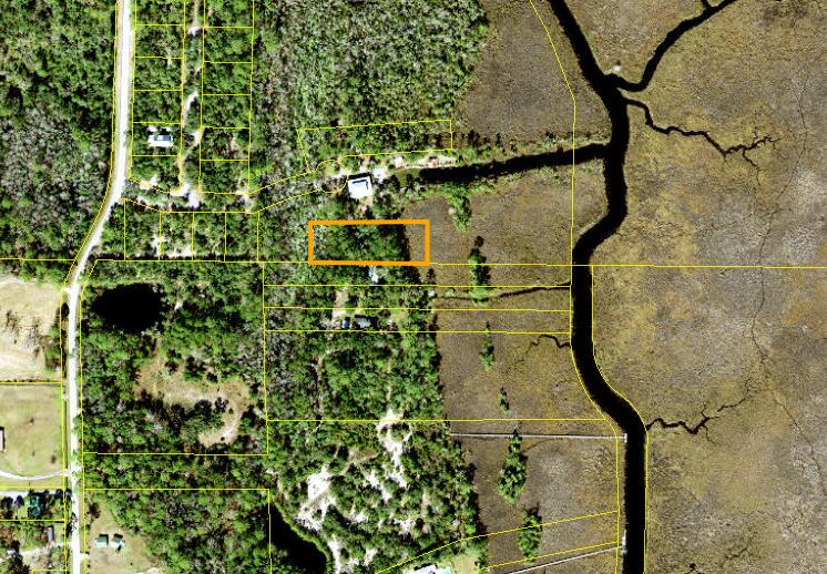 Rare opportunity to own a piece of paradise. Large wooded lot overlooking Scipio Creek. Deeded easement for your own private dock and boatlift. Experience the beauty of Old Florida with magnificent oaks, palms, magnolias, and stunning natural scenery. 
With a community boat launch, dock and boat slip at your doorstep, this property promises an idyllic blend of natural beauty, wildlife, birdwatching, and waterfront living. Hop in your boat, kayak, or paddleboard and explore endless water adventures. From this location, you are just 3.5 miles from the riverfront dock in Apalachicola, where you can enjoy ''dock and dine'' experiences. Two hour drive from two major airports. Just across the bridges from St. George Island's white sand beaches. Whether you're envisioning a forever home or a weekend getaway, this properterty checks all of the boxes.