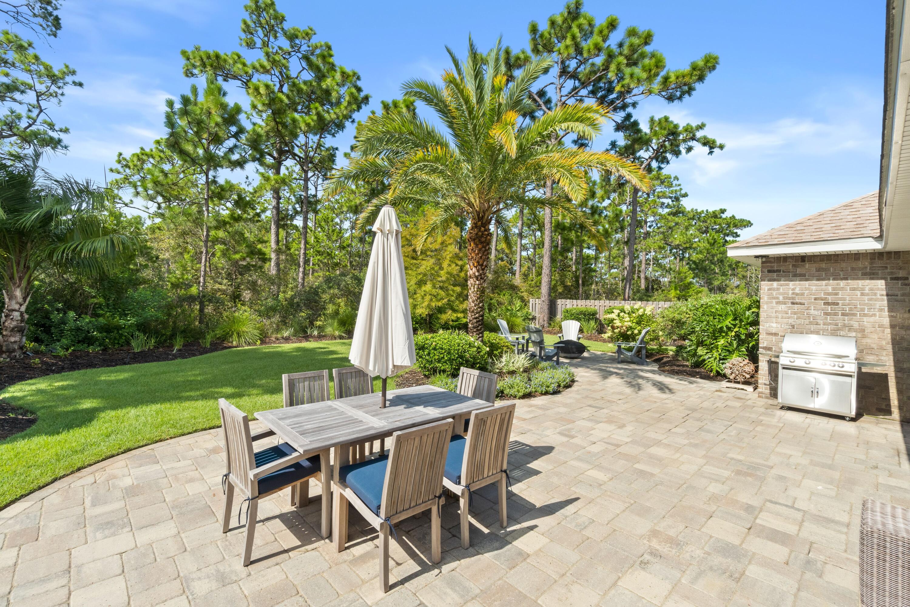 Nestled in Forest Park - a pleasant, cul-de-sac neighborhood - this lovely, well-crafted home offers the perfect location to enjoy our paradise.  Within a couple of miles of the beautiful beaches, excellent shopping & eateries, and ''A-rated'' schools, you will enjoy the best the emerald coast has to offer. Bordering a State Forest, the beautifully landscaped backyard beckons invitingly; offering exceptional backyard privacy and plenty of space for fun activities! The ultimate backyard entertaining space includes a custom paver patio and screened porch.  From the moment you enter the home, the open-concept living spaces welcome you.  Flowing smoothly from the entrance to the living area, into the kitchen and down the hall to the roomy bedrooms, the craftsmanship is evident. The primary bedroom and one of the three additional bedrooms have en-suite baths, plus there is an additional full bathroom.  The spacious upscale kitchen overlooks the backyard and the living area so the chef is part of the action!  This just might be the home you're looking for! (Located in a favorable flood zone, flood insurance not required!)