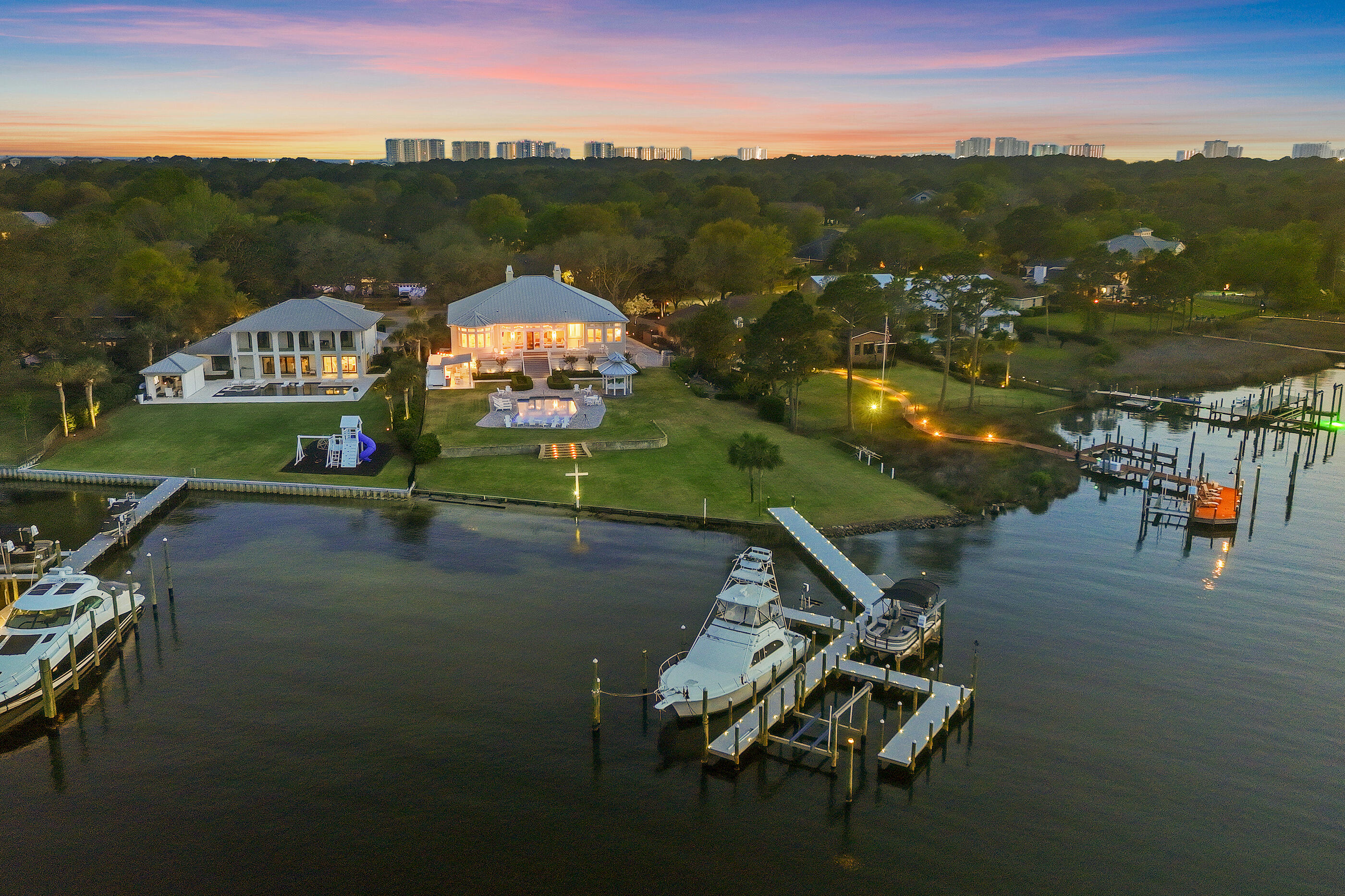 Rare 70'+ yacht-ready waterfront estate with dual deep-water slips in Indian Bayou. Welcome to 124 Indian Bayou Drive, an exceptional opportunity to own a waterfront estate at the mouth of Indian Bayou with sweeping Choctawhatchee Bay views. This yacht-ready residence offers nearly an acre homesite and approximately 158 feet of deep-water frontage, ideal for serious boaters and coastal lifestyle seekers. Hurricane-rated windows and French doors frame striking bayou and bay vistas from almost every room, setting the tone for refined waterfront living. This is a boater's paradise. The private mini marina features two lifts and two protected deep-water slips: one accommodating yachts over 70 feet and another for vessels up to 45 feet. Relax waterside while watching dolphins, sunsets, and the ever-changing colors over the bay. The rare sandy shoreline is ideal for paddleboard and kayak launches, creating an easy on-the-water lifestyle right from your backyard. No other Destin home so seamlessly combines panoramic bay and bayou views with yacht moorings, a private marina, expansive estate grounds, and iconic Southern architecture.

Step inside to a luxurious, thoughtfully updated interior. The gourmet kitchen showcases illuminated, floor-to-ceiling glass-fronted cabinetry, granite countertops, a large breakfast bar, and expansive bay windows framing serene views of the water and pool. This space is perfect for both culinary artistry and effortless entertaining. The living area, sunroom, and primary suite all open onto a classic Southern-style back porch and gazebo, creating seamless indoor-outdoor living.

The newly refinished saltwater pool and pavered deck are enhanced by fiber-optic lighting, offering an enchanting ambiance for evening gatherings and waterside events. From casual family time to cocktail parties under the stars, the outdoor spaces are designed for year-round enjoyment. Gentle bay breezes, wide open water views, and lush landscaping complete the resort-style setting.

Along with the primary suite, there are two additional bedrooms and bathrooms on the main level, providing comfortable accommodations for family or guests. The layout is ideal for single-level everyday living while still offering excellent separation of spaces. Elegant finishes and timeless architectural details create a warm, welcoming atmosphere throughout the home.
Access the versatile lower level by elevator or stairs to discover a true retreat. Here you'll find an in-law suite and an entertainment suite, plus two more bedrooms, two bathrooms, and a three-car garage that can be stacked for up to eight cars. This level is designed for flexible living--ideal for a gym, lounge, storage, or showcasing a prized car collection. A whole-house generator provides uninterrupted comfort and peace of mind.
Situated within the desirable Indian Bayou golf community in the heart of Destin, this home offers the perfect blend of family-friendly living and resort-style luxury. Residents enjoy proximity to a premier semi-private golf course, top-rated schools, shopping, dining, and the sugar-white beaches of the Emerald Coast. This address truly delivers the ultimate coastal lifestyle in one of Destin's most established neighborhoods.
Experience the Emerald Coast lifestyle at its finest--schedule your private tour of 124 Indian Bayou Drive and discover why this rare waterfront estate stands apart among Destin's finest bayfront homes. Make this yacht-ready sanctuary your next legacy property.