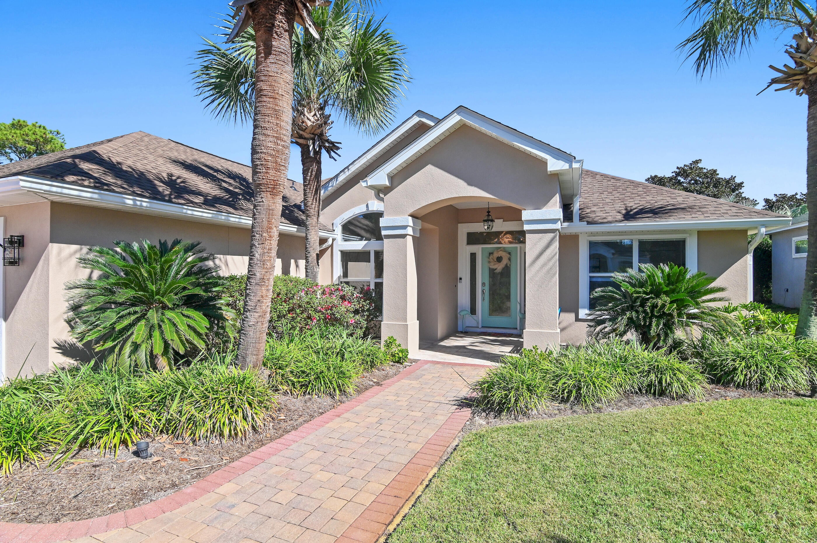 This lakefront home has recently been completely remodeled making it move in ready. This is a one story home located conveniently inside the gated community of the established neighborhood Emerald Lakes. The view of the community lake framed by the screened in lanai and the cathedral ceilings draw your eye straight through the home the moment you step inside. This home features an open split floor plan. The master suite has vaulted ceilings plus a sitting area with another view of the lake and access to the screened in lanai with true outdoor living space.  The master suite bath area has a large 6 X 13 custom walk-in closet, designed by closets by design, with tailored built in storage making smart use of every inch of space. The main bathroom has a new quartz vanity with a soaking tub and a separate tiled walk in shower. This kitchen is a chefs dream and is anchored with a gas stove and oven which opens to the great room which has a gas fireplace as an architectural focal point. This home has a newer roof and also has Hurricane shutters for added peace of mind. This home also boasts a large circular paver driveway adding to its spectacular curb appeal.