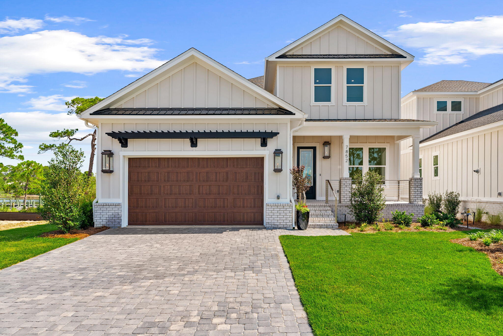LAGOON LIVING with boat slip and dock in the exclusive gated community of Grand Lagoon Pointe, where luxury waterfront living meets direct boating access to the Gulf of Mexico. This premier Lot 6 Dolphin Plan offers 3 bedrooms, 3 full bathrooms, plus an office/flex game that can easily function as a fourth bedroom. Designed for both everyday living and effortless entertaining, the open-concept main living area features a stunning 72-inch gas fireplace and a chef-inspired kitchen complete with a 48-inch professional gas range, oversized island, custom cabinetry, and premium finishes throughout. Just off the game room, you'll find a dedicated entertainment bar, creating the perfect space for hosting family and friends. The primary suite is conveniently located on the main level, offering peaceful views of Grand Lagoon. Multiple covered porches provide the perfect setting to relax with your morning coffee, unwind after a day on the water, or watch dolphins play right from your backyard. Outdoor living is equally impressive with an outdoor bar, ideal for entertaining after a day of boating or fishing. The lower-level basement storage is thoughtfully designed with plenty of room for kayaks, paddle boards, fishing poles, water toys, and comes prepped with an ice maker stub-out. Each waterfront homesite includes a boat slip providing direct access from Grand Lagoon to the Gulf of Mexico. Residents also enjoy a community pool, green space, and a prime location to beach access.