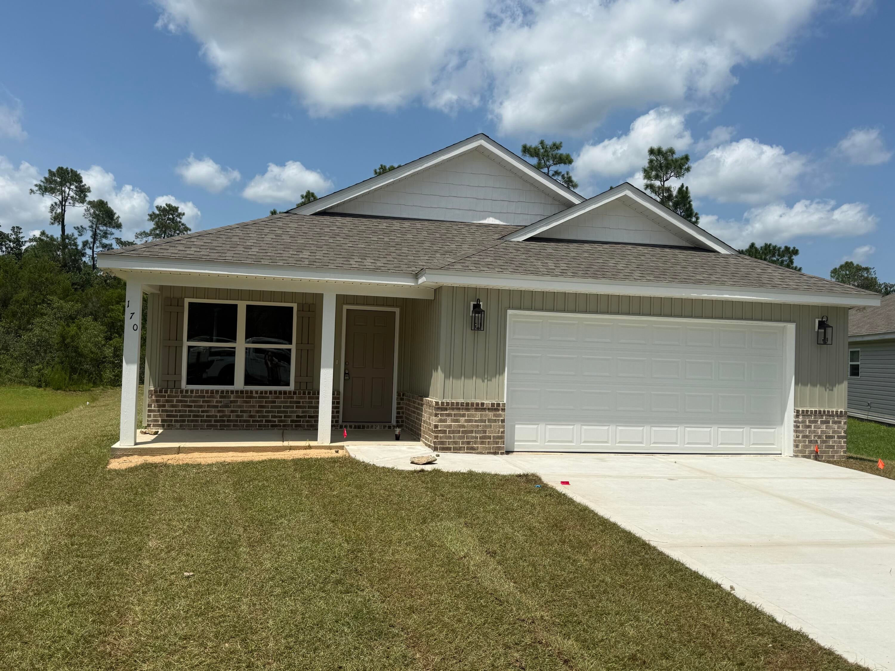 Welcome home to this beautiful brand-new 4-bedroom, 2-bath home, conveniently located in DeFuniak Springs with easy access to the stunning Emerald Coast beaches!

From the moment you arrive, you'll love the welcoming front and back porches, attractive vinyl and brick siding, and spacious 2-car garage.

Inside, the home features an inviting open layout with cathedral ceilings in the living room, creating a bright and spacious atmosphere. The kitchen offers a walk-in pantry and plenty of room for everyday living and entertaining. A convenient mud bench provides the perfect drop zone for shoes, bags, and daily essentials.

The private master suite is designed to feel like your own retreat, featuring:
✨ Double vanity
✨ Separate freestanding soaking tub
✨ Beautiful tiled shower
✨ Large walk-in closet

With 4 bedrooms, 2 full bathrooms, a garage, gorgeous porches, stylish finishes, and a thoughtfully designed floor plan, this home offers the perfect combination of comfort, function, and modern style.

Come take a look and make this beautiful new home yours!