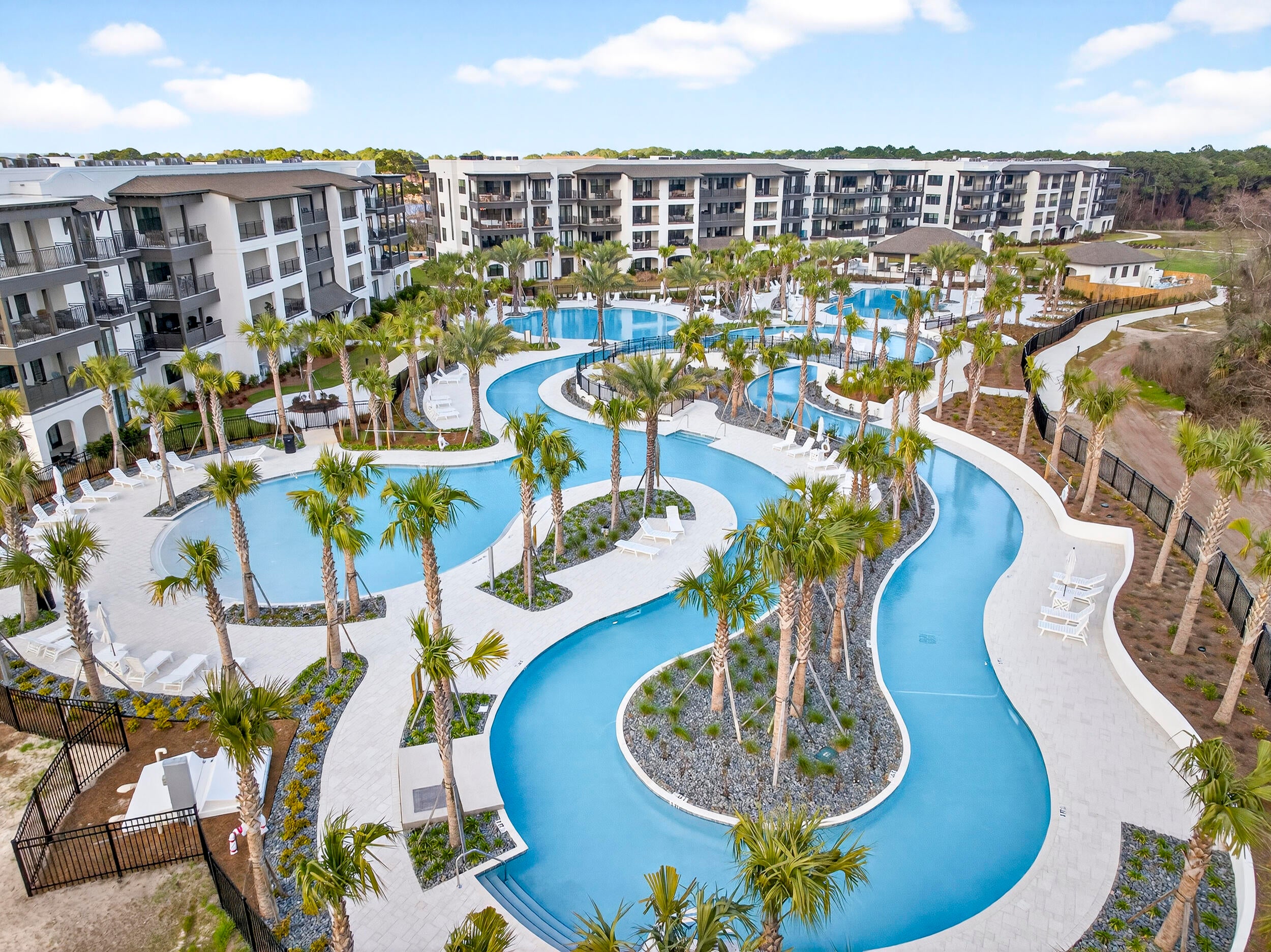 Welcome to the brand new Grove at Seascape with gorgeous tropical pools and a lazy river!  This brand new construction short term rental friendly beach condo offers nearly 2,400 square feet of space, featuring 4 spacious bedrooms and 4.5 baths, each bedroom with its own private ensuite for comfort and privacy. Inside, you'll find 9 foot ceilings, luxury vinyl plank flooring, quartz countertops, soft close cabinets, gas range, and high end Bosch appliances. Designer touches like decorative barn doors add character, oversized closets and abundant storage included. This is truly turn key and comes fully furnished.  Featuring an oversized balcony overlooking the stunning tropical pools, palm trees, and lazy river.  Seascape Resort is one of Miramar Beach's popular resort communities, offering owners and guests the beach lifestyle with the added bonus of resort amenities and entertainment. Beautiful white-sand Gulf beaches plus a wide variety of amenities, including multiple pools, golf, tennis, pickleball, dining, and convenient access to shopping and entertainment. One of Seascape's unique attractions is Moon Crush, a popular live-music experience that brings nationally recognized artists to the resort for unforgettable concert weekends to enjoy or benefit from shoulder season rentals. For homeowners and investors, the combination of Gulf-front access, extensive amenities, dining and entertainment, and a strong vacation atmosphere makes Seascape an especially appealing destination for both personal enjoyment and short-term rental opportunities.