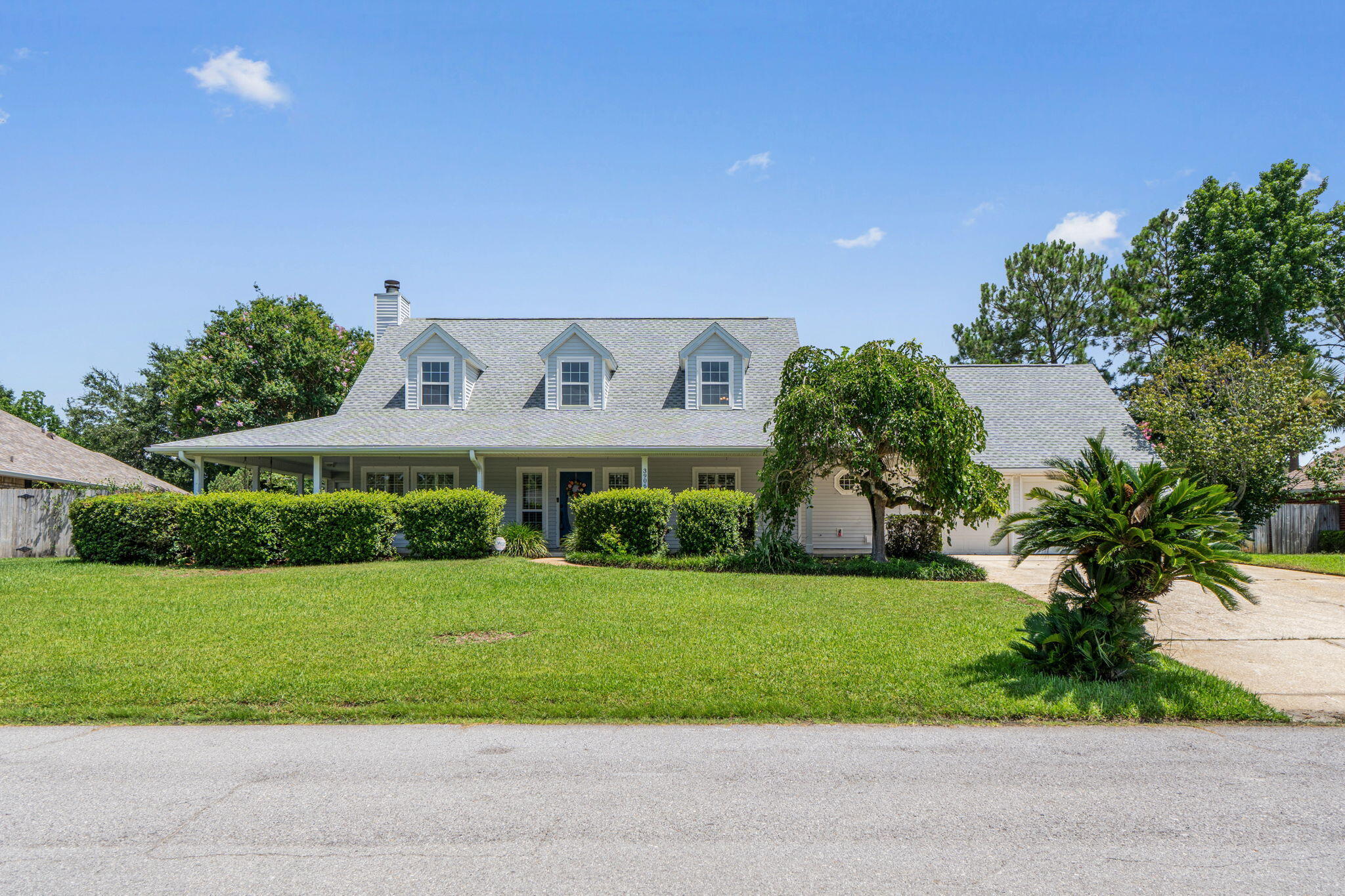 The newest listing in the highly sought-after Tiger Point Community is officially on the market!! This pool home with exceptional curb appeal and an ideal floor plan featuring 3 bedrooms, 2.5 baths, with the primary suite and a dedicated home office conveniently located on the first floor. Relax and unwind on the charming wrap-around porch enhanced with stamped concrete and plenty of room for porch swings, rocking chairs or outdoor lounging. Mature landscaping provides added privacy and creates a welcoming outdoor retreat. The screened back patio has also been updated with stamped concrete and overlooks the sparkling in-ground pool making it the perfect place for entertaining or enjoying peaceful evenings at home. Situated on a quiet cul-de-sac just off Tiger Point Boulevard, this property offers a private backyard with no rear neighbors, providing a rare combination of tranquility and convenience. Walmart and the Publix shopping center as well as the Tiger Point Park are located just around the corner, and a few minutes away. Updates include a new roof (June 2026), water heater (2026), updated HVAC system with new ductwork, and new dishwasher (July 2026). This home is full of character and offers the perfect opportunity to add your personal style and updates while enjoying one of Tiger Point's most desirable locations. Schedule your private showing today and imagine the possibilities!!