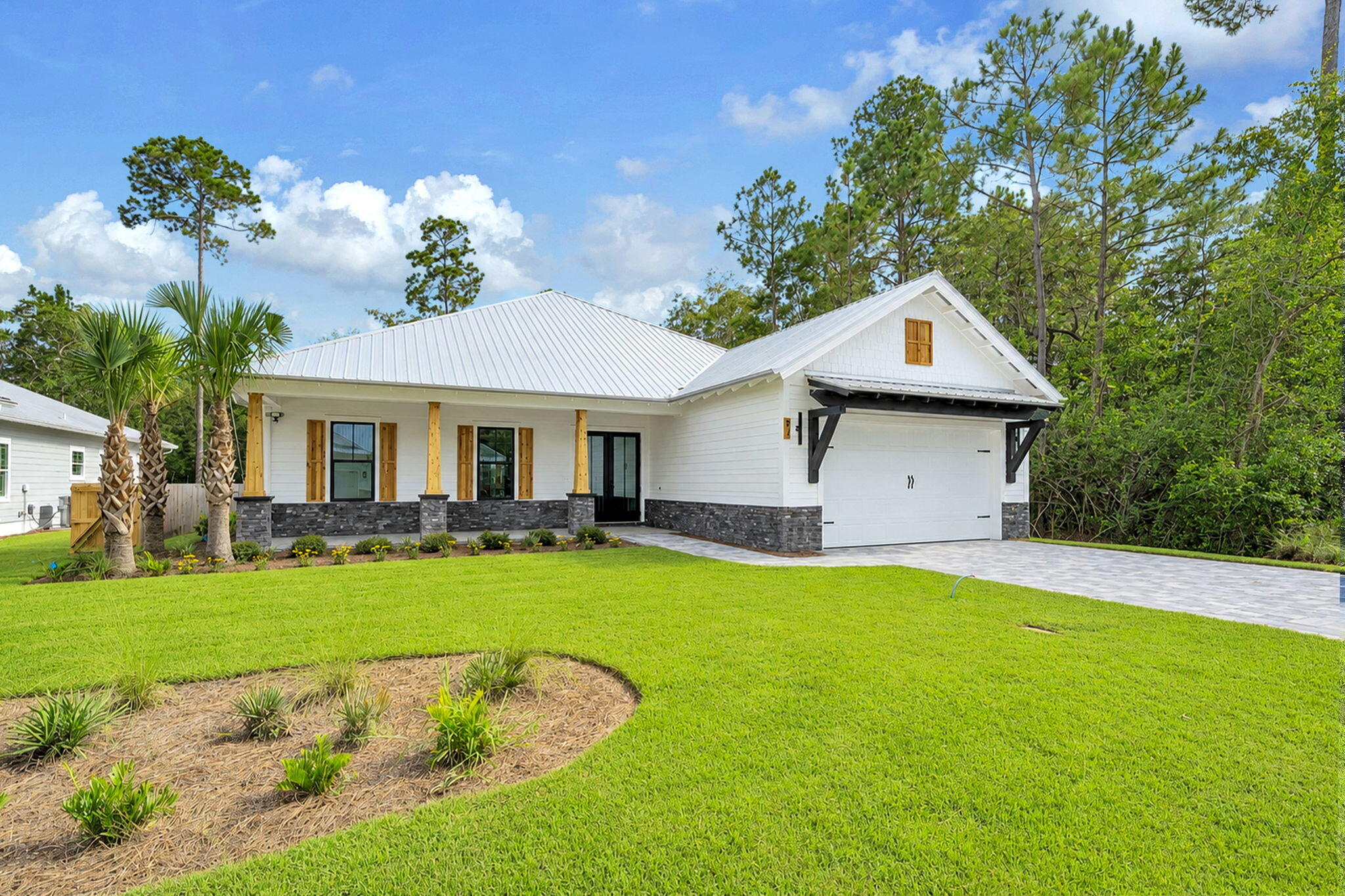 NEW PRICE | CUSTOM CRAFTSMANSHIP WITHOUT THE CUSTOM PRICE TAG. For the buyer who refuses to settle for cookie-cutter, this is the home you've been waiting for. Just 15 minutes from the sugar-white beaches, acclaimed restaurants, boutique shopping, and coastal charm of Scenic Highway 30A, this exceptional new construction offers the perfect blend of luxury, convenience, and value.

This highly crafted Modern Farmhouse with refined Coastal Craftsman architecture is move-in ready and situated on an oversized homesite. Built by one of South Walton's most highly tenured and respected custom builders, this exceptional residence showcases quality craftsmanship, timeless design, and elevated finishes throughout.

Located within the gated, resort-style community of Bear Creek in South Freeport, this thoughtfully designed single-level home offers 2,421 square feet, 4 bedrooms, and 3 baths. From the moment you enter, you'll appreciate soaring 10-foot ceilings, a subtly illuminated 12-foot tray ceiling with Cypress beams, designer finishes, and a warm architectural aesthetic. The light-filled open-concept living, dining, and kitchen areas are designed for effortless entertaining and everyday living.

The gourmet kitchen features a premium KitchenAid appliance package, Sharp microwave drawer, an expansive island with seating for four, a custom Pecky Cypress vent hood, and a beautifully appointed wine bar with matching shelving--creating a stunning centerpiece for gathering with family and friends.

The split-bedroom layout enhances privacy, with a true primary retreat featuring a spa-like bath with freestanding tub, illuminated anti-fog mirrors, oversized walk-in shower, and a showstopping built-in custom closet with an 8-drawer dresser. Guest spaces include a private suite-style bedroom with barn door partition.

Outdoor living is equally impressive with extended covered front and rear porches featuring tongue-and-groove cedar ceilings, cedar columns, shutters, and a seamless indoor-outdoor flow. The home also opens to an exceptional wooded backyard setting--private, peaceful, and full of potential--ideal for a future pool, outdoor living expansion, pets, children at play, or simply creating your own backyard retreat surrounded by nature.

Smart home and efficiency upgrades include integrated audio wiring (living, primary bath, and porch), landscape speakers, security system readiness, WiFi boosters, MyQ-enabled garage, foam roof insulation, impact-rated windows and doors, and abundant attic storage. Exterior craftsmanship includes a paver driveway, stone and cedar accents, even 6.5" Galvalume gutters -- all contributing to elevated coastal curb appeal.

Bear Creek offers an unmatched resort-style lifestyle in South Freeport, with pools (including zero-entry), clubhouse, fitness center, tennis, pickleball, basketball, playgrounds, and green space. The location is just minutes to Grady Brown Park and bay access, and only minutes to the beaches, dining, and shopping of Scenic 30A--offering the perfect balance of bay life, beach life, and community living.

A rare opportunity to own a thoughtfully designed, move-in ready home where luxury, function, and location align.

*All listing details are deemed reliable but not guaranteed. Buyer to verify all information deemed important.