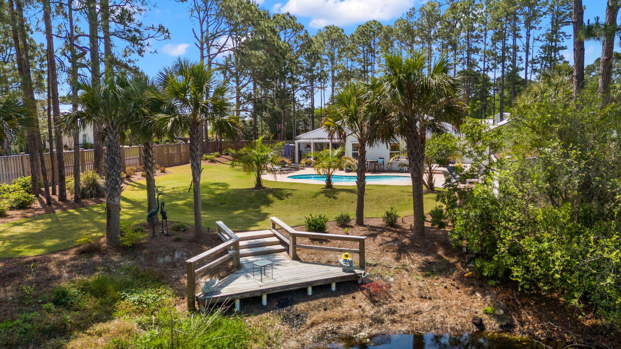 Don't miss this special new buyer incentive! Seller is offering $20,000 toward buyer closing costs and prepaids. With an acceptable offer, seller will also fully renovate the kitchen, dining room, and laundry room, and install new flooring throughout -- giving buyers a rare chance to customize this coastal estate to their taste while locking in today's price. Experience a rare sense of privacy, tranquility, and investment potential at this coastal estate at 10 Fairway Drive. Ideally situated just minutes to the beach on a generous 0.58-acre corner lot, this property offers space between homes and a room to breathe feel that can be hard to find along the 30A corridor. Topped with a brand new custom-color metal roof (installed May 2026), this home arrives turnkey, fully furnished, and ready to enjoy immediately. 
The crown jewel of the estate is the expansive backyard coastal oasis, enclosed entirely by an 8-foot shadowbox privacy fence. Here you'll find a natural coastal dune pond -- a self-sustaining ecosystem stocked with bass, bream, and catfish, perfect for a quiet afternoon John-boat ride or a morning of fishing off your private dock. The grounds are rounded out by a resort-style heated pool, fire pit, mature landscaping, and white peach trees. Located just minutes to the beach in the exclusive non-HOA community of Santa Rosa Ridge, this home makes for a perfect primary residence or second home. Maximize your ROI with this turnkey, fully furnished gem featuring a proven rental history and active bookings already in place. The main residence offers single-story living with four bedrooms plus a dedicated bunk room that comfortably sleeps 10. Expanding the footprint is a detached, climate-controlled garage | carriage house--a versatile flex space currently serving as a game room but easily converted to a fifth bedroom or private office. With vaulted ceilings, a chef's kitchen, and a prime location minutes from the beach and local amenities, this property offers the space and flexibility typically reserved for a much higher price bracket.

Located just off of CR393, this home is located an easy walk, golf cart or bike ride to 30A and the sugar white beaches and turquoise water of the Gulf. Convenient to popular dining and casual hotspots such as: Shunk Gulley, Shelby's Beach Bar, Perfect Pig, Pecan Jack's and the local Growler Bar. Plus shopping, coffee and souvenir shops, this is not just living at the beach. This property on the west end embodies the best the 30A lifestyle has to offer. Buyer to verify all dimensions. Home is fully-furnished with a small list of exclusions. Rental schedule and actuals available upon request.