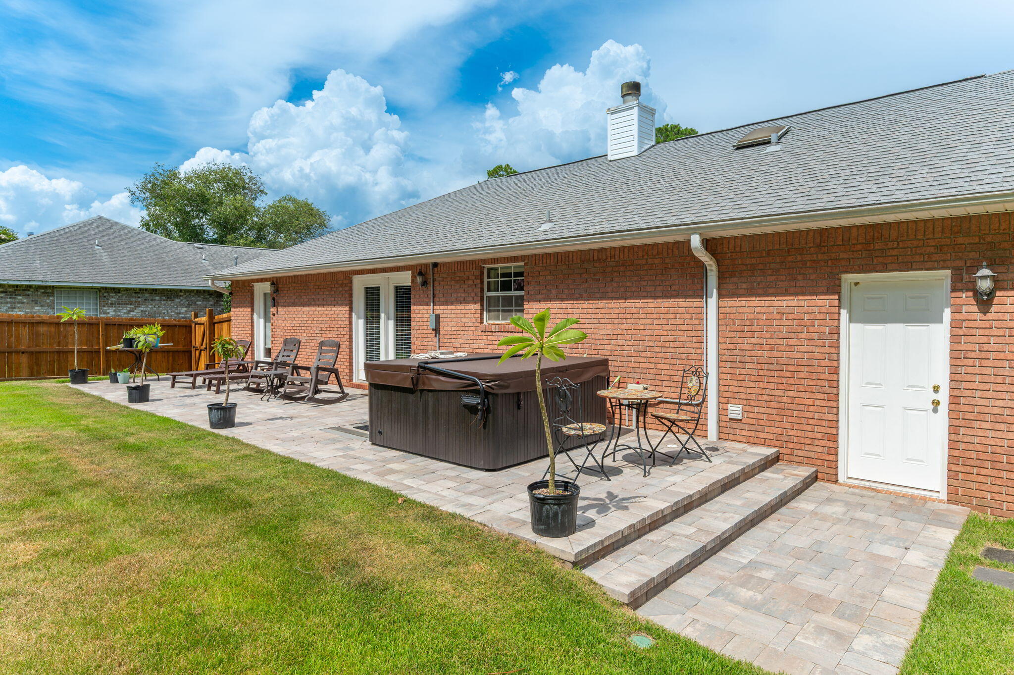 Welcome to this charming all-brick 3-bedroom, 2-bath home in the much-coveted and sought-after Holley by the Sea community. This one-level split floor plan offers easy living with no carpet, a 2022 roof, upgraded appliances added in 2026, ceramic tile in the entry, kitchen, dining, and baths, plus LVP wood flooring in the living room. A cozy fireplace adds warmth and character, while the private primary suite is tucked away from the guest bedrooms. French glass doors off the dining area lead to a peaceful backyard retreat with upgraded landscaping, matured trees, and space to relax or entertain. This home also comes with a new hot tub, Zero Turn John Deere mower, washer, and dryer, adding even more value to this inviting Navarre home making it ready to move in and start enjoying!