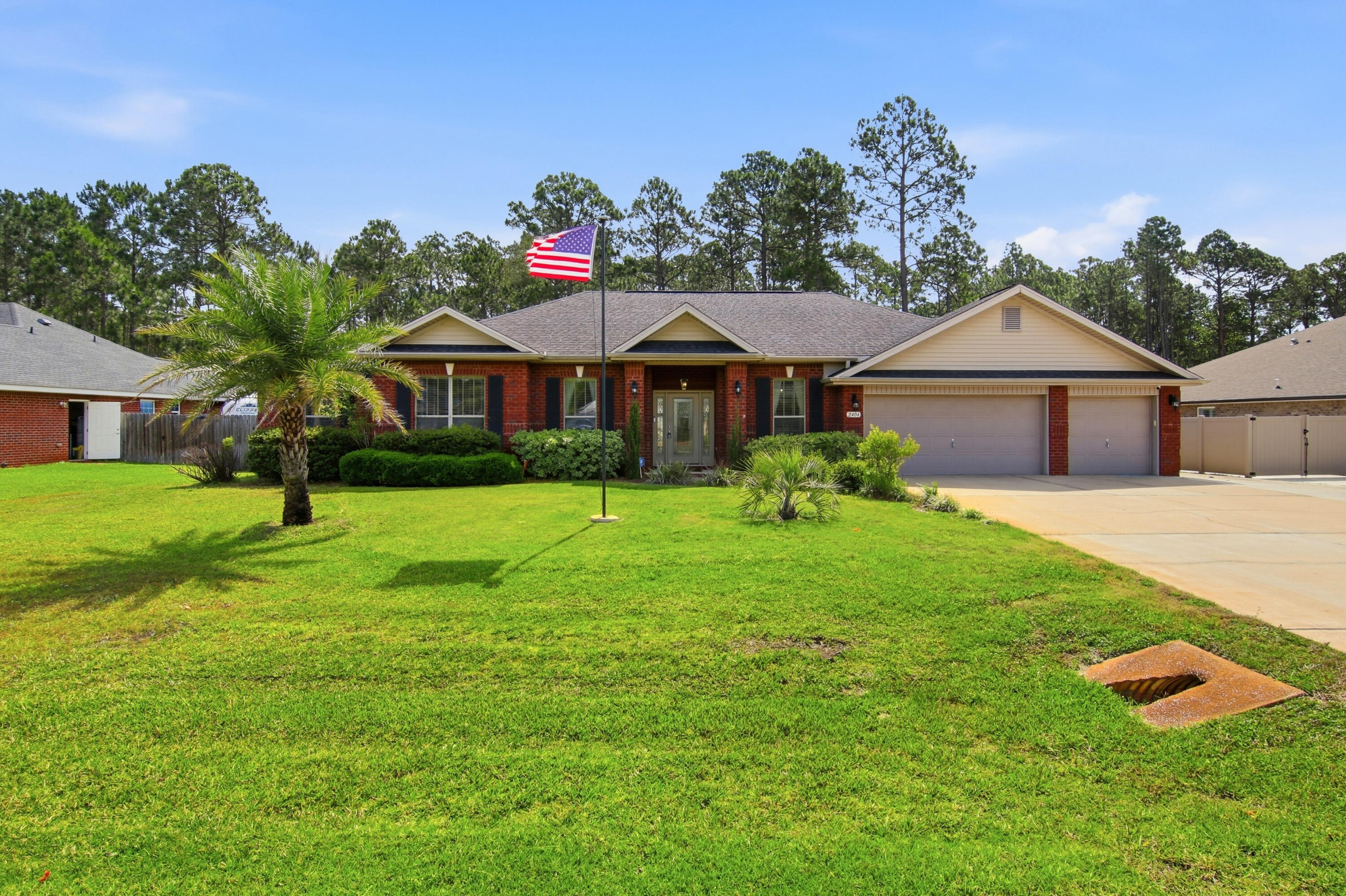 Located in the highly sought-after community of Holley by the Sea in Navarre, this beautifully maintained residence offers an exceptional blend of comfort, privacy, and refined coastal living. Set on an expansive .58-acre homesite surrounded by mature trees, the property provides a rare sense of space and seclusion while still being part of one of the area's most desirable neighborhoods. Inside, you're welcomed by a thoughtfully designed split floor plan featuring four spacious bedrooms, two full bathrooms, and a dedicated private office--ideal for remote work or a quiet study without sacrificing a bedroom. The interior is enhanced with durable COREtec wood-look plank flooring throughout the main living areas and bedrooms, creating a cohesive and modern feel with no carpet in sight.

At the center of the home, the kitchen is designed for both everyday living and entertaining, offering granite countertops, stainless steel appliances that have been well maintained with routine service and are in excellent working order, a high-top breakfast bar, a generous pantry, and a bright breakfast nook that fills the space with natural light.

The primary suite is a true retreat, accessed through elegant French doors and offering an oversized layout with plenty of room to unwind. The en-suite bath impresses with its scale and features, including an expansive walk-in shower and abundant space throughout. On the opposite side of the home, the additional bedrooms provide privacy and convenience, with the second bathroom offering direct access to the backyard--perfect for outdoor living and entertaining.

One of the standout features of this property is the immaculate three-car garage, complete with a glossy epoxy floor finish and built-in storage cabinetry, making it as functional as it is impressive.

The exterior living spaces are equally inviting, featuring a fully fenced backyard, covered patio, and a wood deck that overlooks the natural wooded backdrop. Additional highlights include a sprinkler system on a private well, underground utilities, Levelor blinds throughout, fabric hurricane window protection, and sewer service (no septic).

This is a rare opportunity to own a spacious, well-appointed home in Holley by the Sea that offers both privacy and convenience, all within a highly desirable coastal community with incredible amenities and lifestyle appeal.