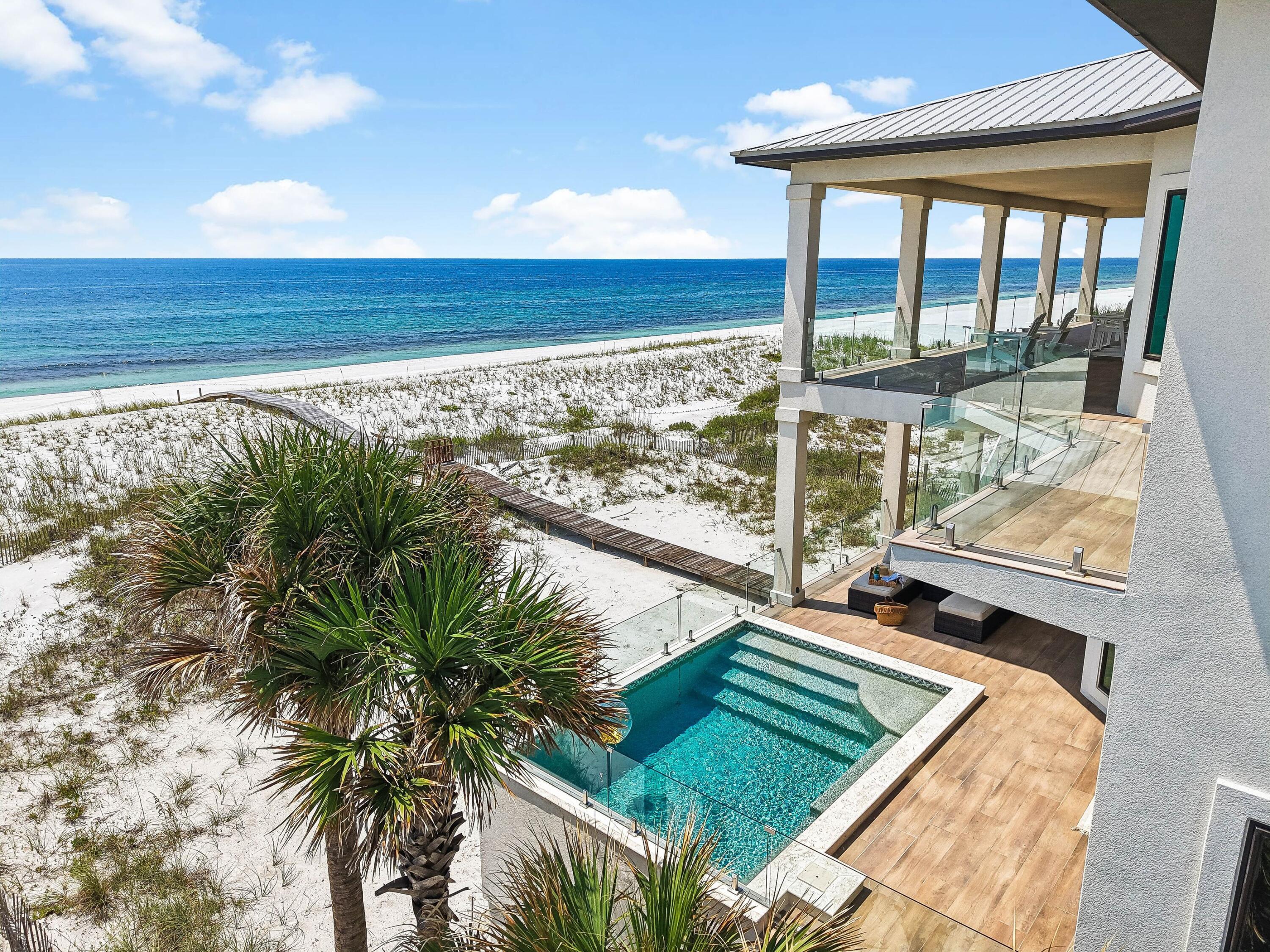 There are beachfront homes, and then there are properties that redefine a market. Nothing of this caliber has ever been offered for sale on Navarre Beach. Set directly along the sugar-white sands and emerald waters of the Gulf of Mexico, 7321 Gulf Boulevard is an extraordinary gulf-front residence distinguished by 95 feet of private frontage, exceptional concrete construction, and a level of engineering and refinement rarely seen on Navarre Beach. Completed in 2023, meticulously maintained and never rented, the three-story residence encompasses approximately 5,499 square feet of conditioned living space and more than 10,600 total square feet. Just three homes from Gulf Islands National Seashore, it enjoys a remarkable setting near miles of federally protected shoreline, pristine dunes and uncrowded beaches--a sense of privacy and natural beauty increasingly difficult to find along the Gulf Coast.

Built with insulated concrete forms (ICF), masonry framing and hard-coat stucco, the home incorporates a reinforced concrete foundation, impact-rated windows and doors, and two geothermal HVAC systems. The result is a residence engineered specifically for its coastal environment, where luxury extends well beyond what is immediately visible.

Inside, six bedrooms and six-and-one-half baths unfold across three beautifully considered levels connected by a custom elevator. Each bedroom features a private ensuite bath, while floor-to-ceiling gulf-facing glass captures sweeping water views throughout the primary living spaces. An elegant kitchen appointed with Thermador appliances anchors the open living and entertaining areas, complemented by a fireplace, dedicated theater and whole-home audio.

Expansive 15-foot-wide concrete terraces extend the living experience toward the water, where an elevated concrete pool with both heating and chilling capabilities overlooks the dunes, white sand and gulf beyond. A climate-controlled game and entertainment area provides additional space for gathering, with doors opening toward the gulf for seamless indoor-outdoor living.

A gated entrance, established tropical landscaping, full fencing and generous parking complete a property designed with equal consideration for beauty, privacy and longevity.

And then there is Navarre Beach itself. Known for its sugar-white sand, emerald-green water and miles of protected natural beauty, this barrier island retains a serenity and authenticity increasingly rare along the Gulf Coast. Here, mornings begin with the sound of the surf and sunsets are experienced from your own stretch of one of Florida's most beautiful shorelines.

Rare in its construction. Exceptional in its frontage. Unprecedented in its market.

7321 Gulf Boulevard represents a new benchmark for luxury on Navarre Beach--an extraordinary coastal residence created with an uncompromising approach to quality, design and longevity.