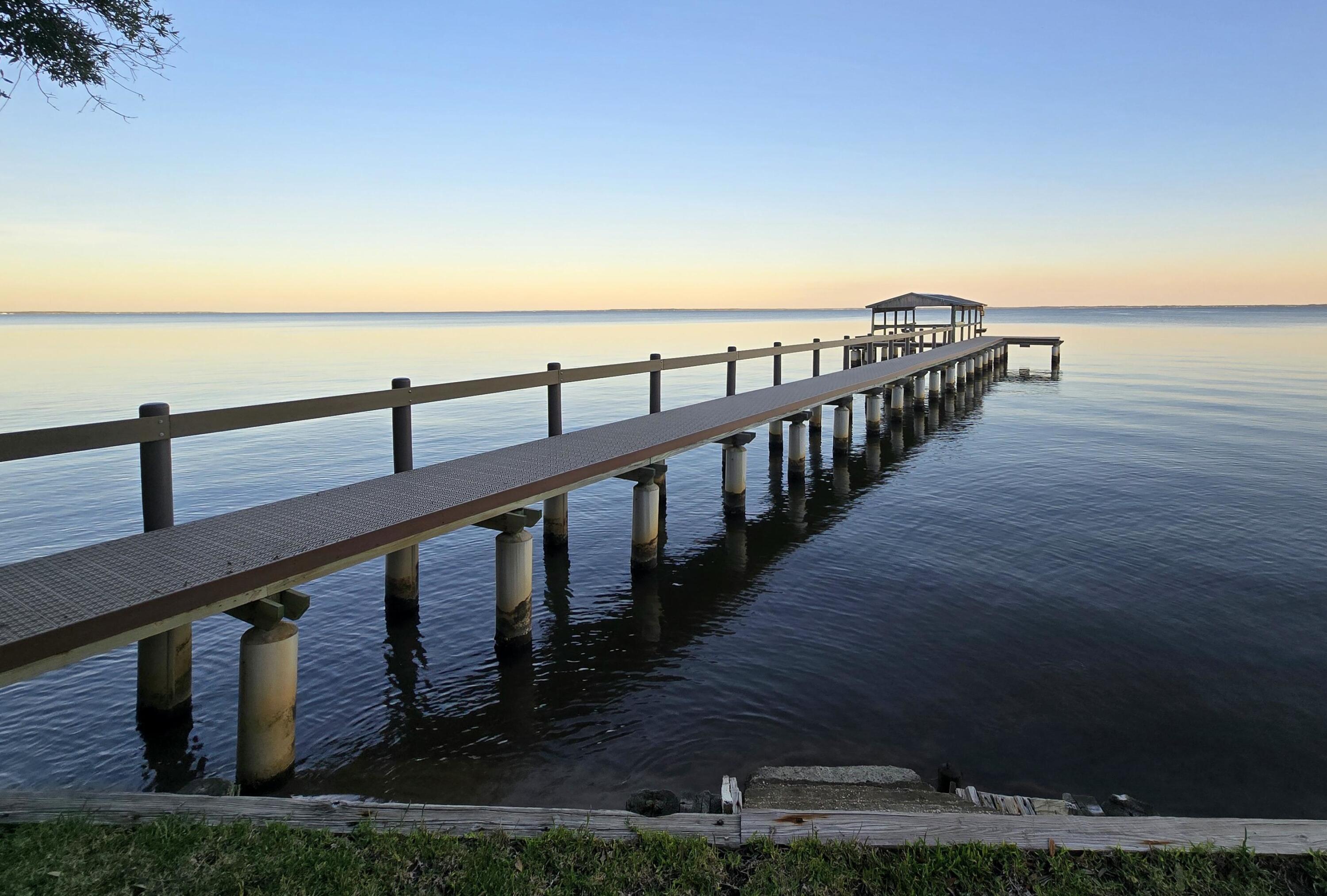 Experience waterfront living with sweeping bay views, a beautifully rebuilt dock, and a setting that makes every morning feel like a getaway. This 3BR/3BA, 3,276 SF bayfront home sits on 0.80 acres and features a private Mother-in-Law Suite with its own entrance, kitchenette, full bath, and walk-in closet - ideal for guests or multigenerational living.

Inside, enjoy cathedral ceilings, skylights, spacious living areas, and a bright sunroom overlooking the water that brings the outdoors in year-round. The kitchen features a Jenn-Air smooth top stove, island with breakfast bar, and stainless/black appliances designed for everyday function and entertaining.

Outdoor living is where this property truly shines, with a beautifully rebuilt dock featuring composite decking and concrete pilings, a raised seawall for added elevation, and wide-open bay views made for sunset evenings and coastal relaxation.

Additional highlights include a metal roof, hurricane shutters, and a 2-car garage. Conveniently located minutes to Niceville, Destin, Hwy 331, top-rated schools, medical facilities, shopping, and dining.

A rare opportunity to own a true bayfront retreat offering space, flexibility, and the coastal lifestyle you've been waiting for.