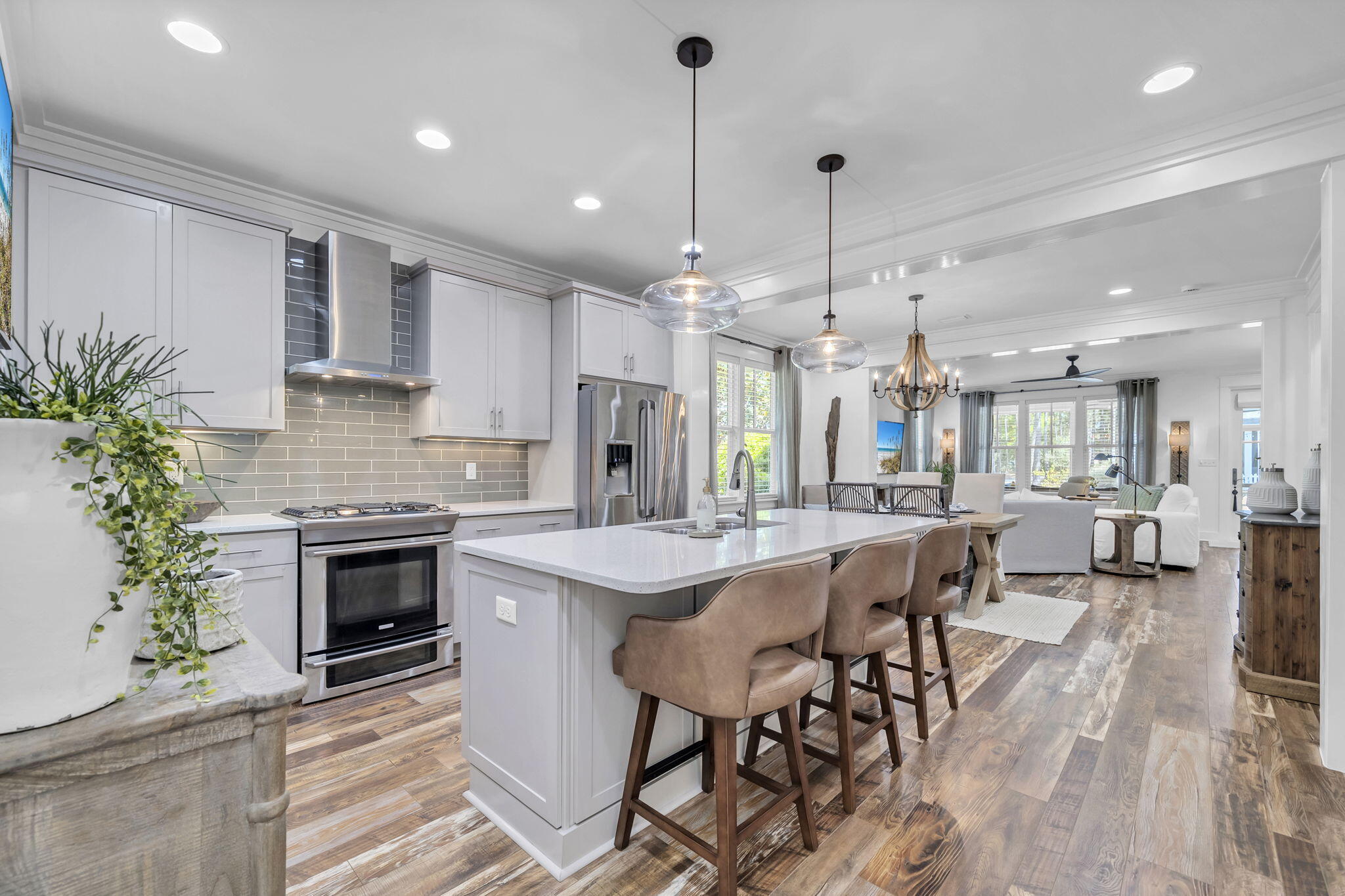 Immaculate single-level 3-bedroom, 3-bath home built by Huff Homes in the sought-after Winter Garden phase of Watersound Origins. This move-in-ready residence sits on a premium lot featuring a side buffer, white picket fenced yard, and beautiful views of landscaped park and natural green space that backs directly to walking trails. Enjoy easy walkability to the Village Commons fitness center and resort-style pool. The open-concept floor plan seamlessly connects the living, dining, and kitchen areas, complete with stainless steel appliances, gas cooktop, large island with breakfast bar, and custom bar nook. Wood-look vinyl plank flooring runs throughout most of the home. The primary suite includes a soaking tub, seamless glass-and-tile shower, double vanity, and custom walk-in closet. Two additional bedrooms and two full baths complete the single-level layout. Outside, a screened porch opens to a paved patio for effortless outdoor living. This rental-restricted community offers golf, tennis, pickleball, gym, pool, playground, and kayaking on Lake Powell with access to 30A beaches near Camp Helen State Park. Just minutes from Scenic Highway 30A's white-sand beaches, dining, and shops. Perfect as a primary residence or second home, this Huff Homes gem delivers exceptional lifestyle, location, and value in a desirable single-level 3 bed, 3 bath floor plan.