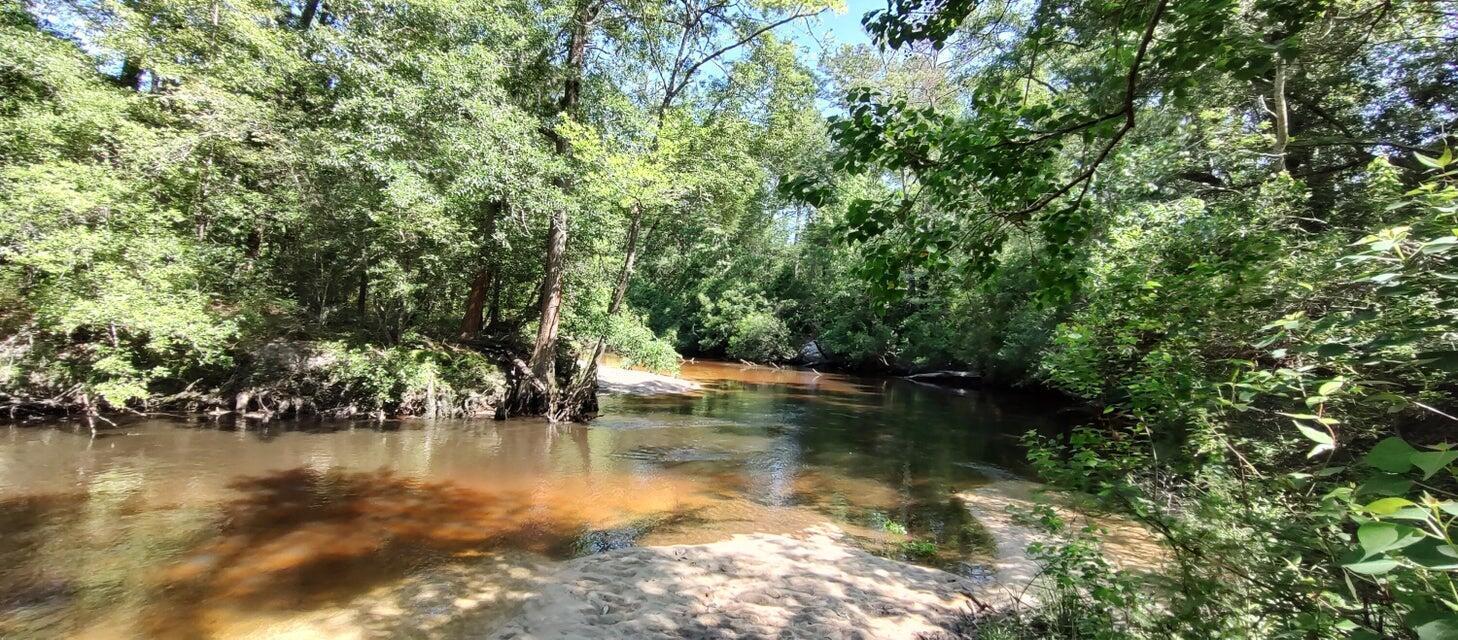 Build Your Coastal/Wooded Retreat!
Beautifully wooded lot backing directly up to the peaceful, Shoal River with almost 400' of river frontage. Enjoy privacy, mature shade trees, and a serene, natural backdrop for your dream home. No tight builder timelines or restrictive home designs--bring your own builder and craft your private oasis. Perfect for buyers seeking tranquil surroundings without sacrificing convenience to town.  Property has electric pole and water. LOT 14 is for sale and can be purchased together for almost 10 acres total.
