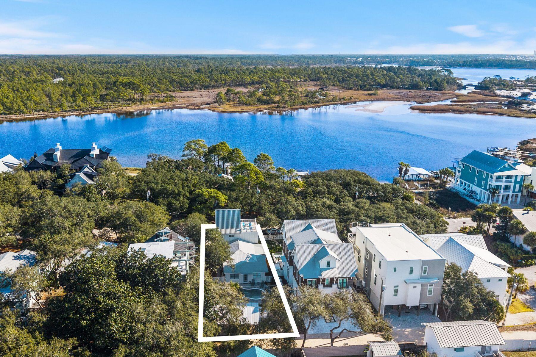 A Grayton Beach rarity: Western Lake views, a private guest cottage, a resort-style pool, and projected rental income of up to $373,000 annually, combine to create a property as versatile as it is unforgettable.

Timeless Grayton Beach character meets thoughtful modern renovation in this rare fully-furnished, dual-residence offering just steps from Western Lake, the shoreline, and the heart of one of 30A's most storied beach villages. Originally built in 1970 and extensively reimagined, the property pairs a gracious main home with a fully detached private cottage, creating flexibility for hosting, multigenerational living, or income potential without sacrificing privacy or charm.
The main residence spans approximately 2,910 square feet with five bedrooms and four-and-a-half baths across three levels. Recent updates include a fully redesigned kitchen, renovated bathrooms, fresh interior paint, new flooring, updated wiring and plumbing, two HVAC systems, new appliances, and a new roof. From the inviting front porch, morning coffee is enjoyed with tranquil views toward Western Lake. Inside, the first floor opens to a generous living and dining area that flows seamlessly into the kitchen, which offers ample space for an island and connects to a comfortable sitting or game room. A mudroom off the kitchen adds a half bath, a full-sized laundry, and direct access to the side yard for grilling.
Two first-floor bedrooms feature updated ensuite baths, while a rear hallway leads directly to the backyard. Upstairs, the second level offers two additional bedrooms and two full baths. The third floor serves as a flexible retreat or bedroom, highlighted by a striking wood A-frame ceiling with access to the large balcony.
The detached cottage provides approximately 560 square feet with one bedroom, one full bath, a family room, a full kitchen, a laundry room, an outdoor shower, and a separate entrance. With a new roof and alley access, the cottage allows easy movement to the beach, lake, and dining while remaining discreetly set apart from the main home.
Outdoor living is equally compelling, with a spacious backyard ready for relaxed afternoons, a newly added private pool, curated hardscape, and lush landscaping. After a day on the water, rinse off at the outdoor shower or unwind in one of several private seating areas. Parking is generous with a paver driveway, additional front parking, and two rear spaces for a total of seven. Accessibility has been carefully considered with a ramp on the north side and a fully accessible first floor, including the primary bath.
Both residences may be rented separately or together, offering exceptional versatility. Positioned moments from Western Lake, two beach accesses, and iconic spots like The Red Bar, Chiringo, and AJ's Grayton Beach, this is a rare opportunity to own a true Grayton Beach classic where coastal history, modern updates, and an unbeatable walkable setting come together with ease.