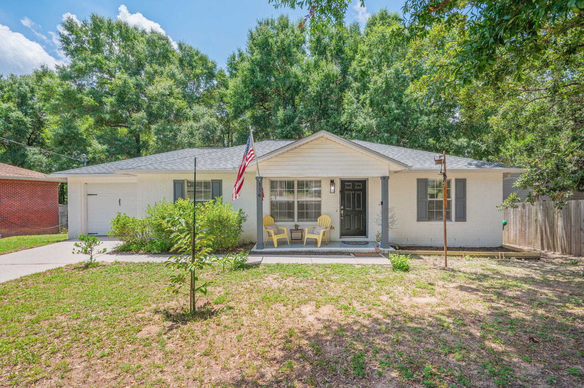 Conveniently located near town, this charming 3-bedroom, 2-bath all-brick home has been lovingly maintained by its owner. Inside, you'll find durable luxury vinyl plank (LVP) flooring throughout, complemented by neutral paint colors that create a warm and inviting atmosphere. The spacious living room flows into a functional galley kitchen with an adjacent dining area, making it ideal for both everyday living and entertaining. All appliances convey, including the washer and dryer, offering added convenience for the new owner. The home features a generously sized primary bedroom, along with two additional well-proportioned bedrooms. Additional highlights include a single-car garage, a newly stained rear wooden deck, and a large, fenced backyard that's perfect for outdoor gatherings, pets, or play.