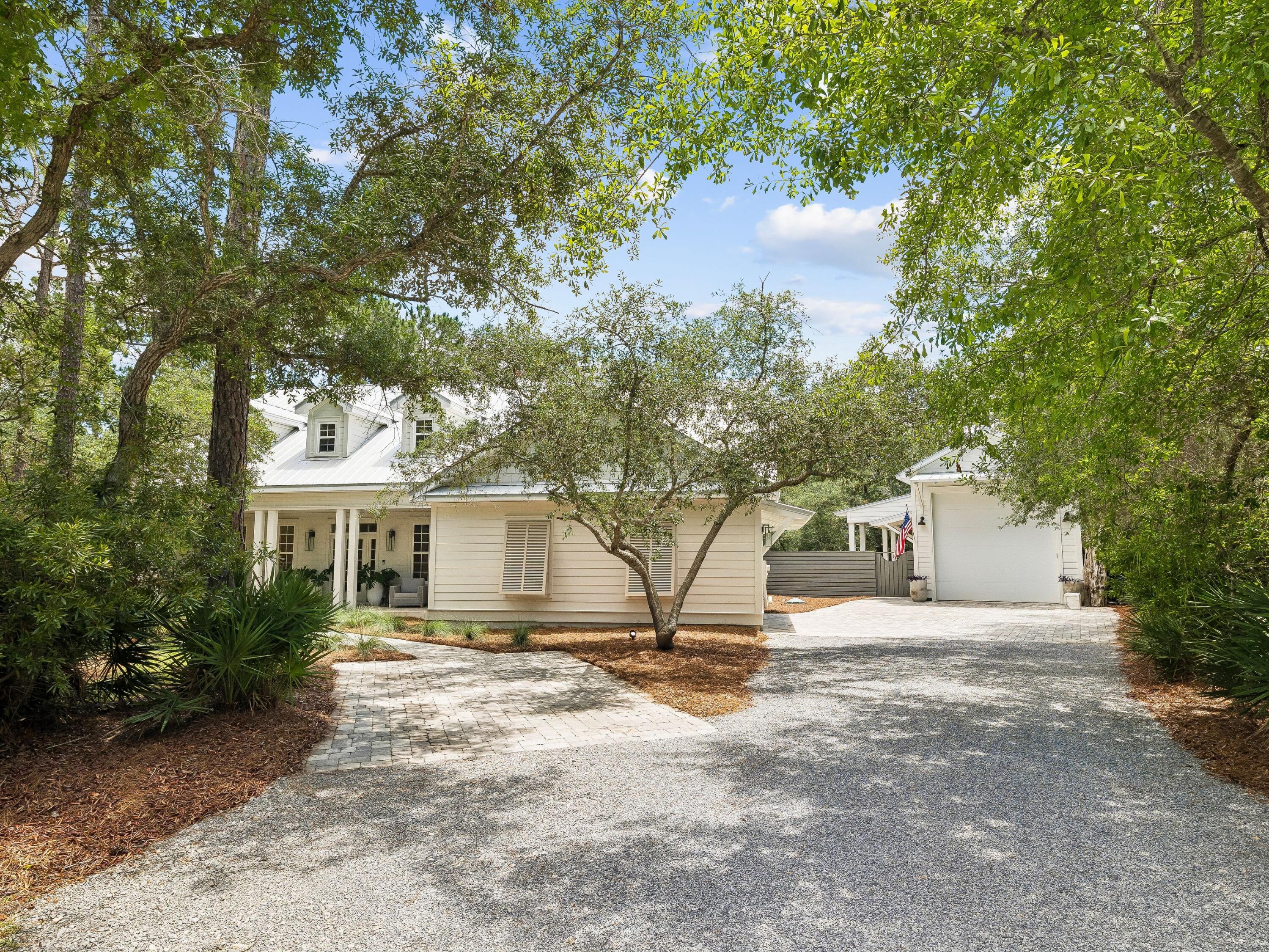 Live the best of both worlds--bay & woods to beach in just 7 minutes, yet tucked away in your own private oasis in the highly sought-after community of The Woods in Point Washington. Ideally positioned in a serene, secluded cove backing to peaceful Ivy Lane and just moments from Choctawhatchee Bay, this sprawling, totally renovated retreat offers the rare combination of privacy, space, and location--with the added bonus of becoming part of a soon-to-be gated community! Grand yet welcoming, this thoughtfully designed home offers effortless first-floor living, featuring a spacious primary suite on opposite side of house from two guest suites connected by a Jack-and-Jill bath--perfect for family or visitors, so three bedrooms on main! Upstairs, a generous den creates an ideal second living space, flanked by two additional bedrooms for comfort and privacy, plus abundant attic storage, a rare find! Outside, towering mature oak trees frame a large fenced backyard designed for both relaxation and entertaining. Enjoy peaceful mornings or evenings on the covered porch, perfectly suited for grilling and gathering. But the true hidden gem of this property is the exceptional 534-square-foot detached garage, in addition to the attached two-car garage--a rare and highly coveted feature ideal for a classic car collection, center-console boat, RV, workshop, or all your recreational toys. New metal roof installed in 2021.  Recent renovated baths boast porcelain and marble tile throughout. The kitchen features honed Taj Mahal quartzite counters and tile backsplash. The backyard is irrigated from a well, and the driveway can accommodate 5-6 vehicles! Tabby stone fireplace with LP logs. The Woods maintains its serene environ with underground utilities and provides fiber internet.  Offering spacious serenity just minutes from the sugar-white sands, this is more than a home--it's a lifestyle retreat wherebeach days and private tranquility beautifully co-exist.