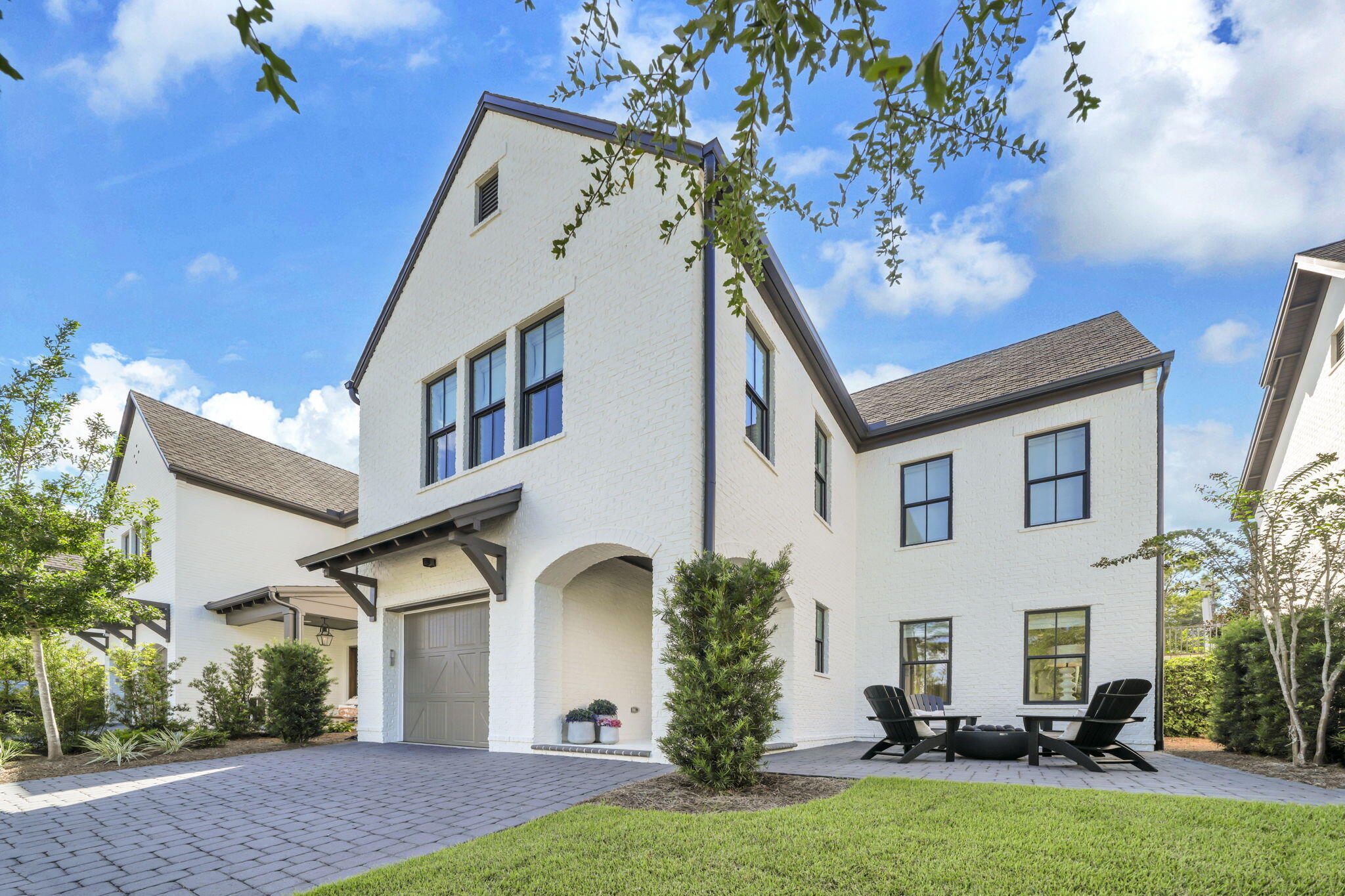 Experience refined coastal living at 46 Ridgewalk Circle, ideally located in a gated, short-term rental-restricted community less than half a mile from Ed Walline Beach Access and all that Gulf Place has to offer. Meticulously maintained, this beautifully appointed home features high-end designer finishes, a striking brick accent wall in the living room, and a gourmet kitchen equipped with Viking appliances and a water purification system. The inviting open layout creates an effortless flow for everyday living and entertaining. Step outside to a private backyard complete with a fully equipped kitchen. Enjoy a gas fire pit, perfect for relaxing after a day at the beach. A garage provides convenient storage for bikes, beach gear, and all your coastal essentials. Perfect as a full-time residence or second home, this exceptional property offers privacy, style, and easy access to the best of 30A.