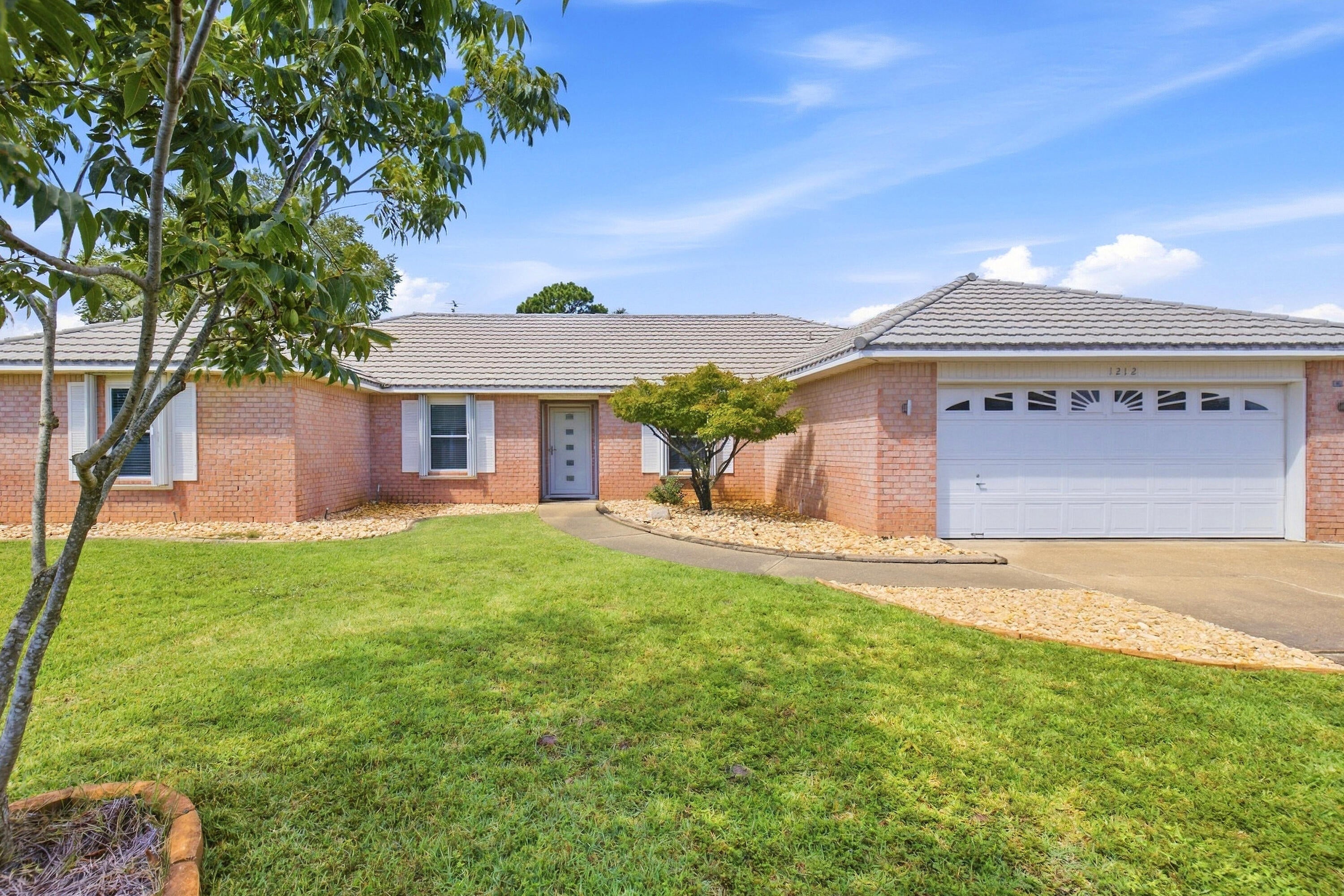 Situated on a spacious 1/3-acre lot in Raintree Estates, this 4BR/2BA Bluewater Bay home offers a comfortable split-bedroom floor plan with room to enjoy both inside and out. The interior features a separate dining room, a versatile flex room currently being used as a bedroom, a roomy living area, and an eat-in kitchen with plenty of space for everyday living. LVP flooring extends throughout the home with no carpet.  The master bedroom includes two walk-in closets, double vanities, a garden tub, and a separate shower. Out back, the screened pool and large screened porch create a great space for relaxing or entertaining, while the fenced yard provides additional outdoor space.  A storage building with electricity offers room for tools, equipment, or recreational items. Major systems include a 2009 metal roof, 2019 HVAC & 2023 water heater.  The voluntary HOA offers access to neighborhood parks, sports fields, playgrounds, nature trails, a pavilion, and a waterfront area with a dock. Conveniently located near shopping, military bases, and Niceville schools, this home offers a great combination of space, outdoor living, and a desirable Bluewater Bay location.