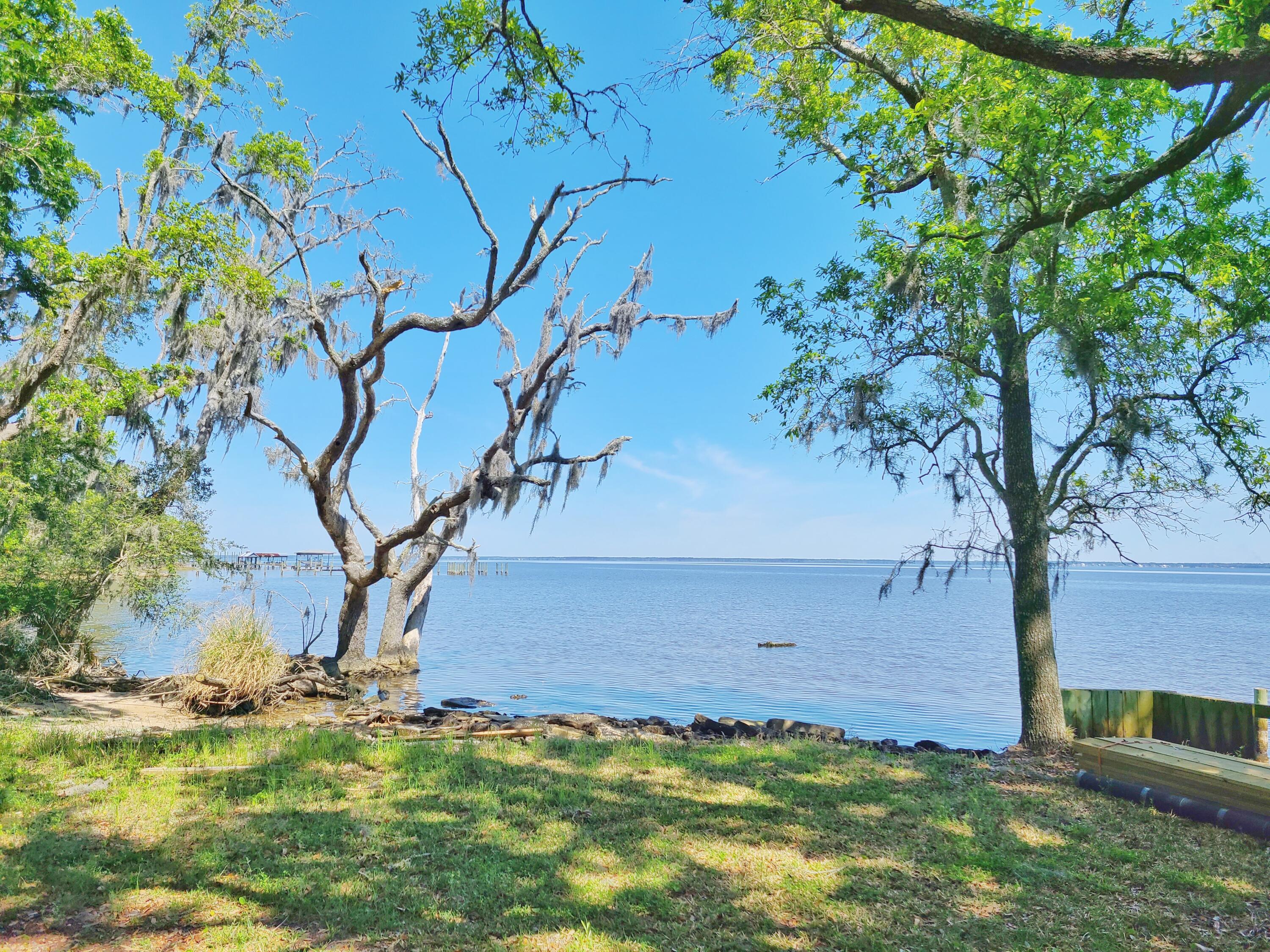 This  is a rare opportunity to own a 6.68 acre property that kisses the bay. Maps indicate about 130-150ft of waterfront. Oaks, Pines and Southern Magnolias dot the property throughout. Current zoning is Neighborhood Infill, up to 8 units per acre. Property could be used for one large estate size spectacular homesite overlooking the water, or work with the county to further develop.  Underground power is at the property. 

To the south of this property is the Kellogg Nature Center with parking and trail to the Kellogg Bay front Park. Coming soon is a new discovery building.

To see the property in person, 24 hour advanced notice required to view the property. Owners live at the property. Call your agent to schedule a time to see the property in person. NO DRIVE BY.