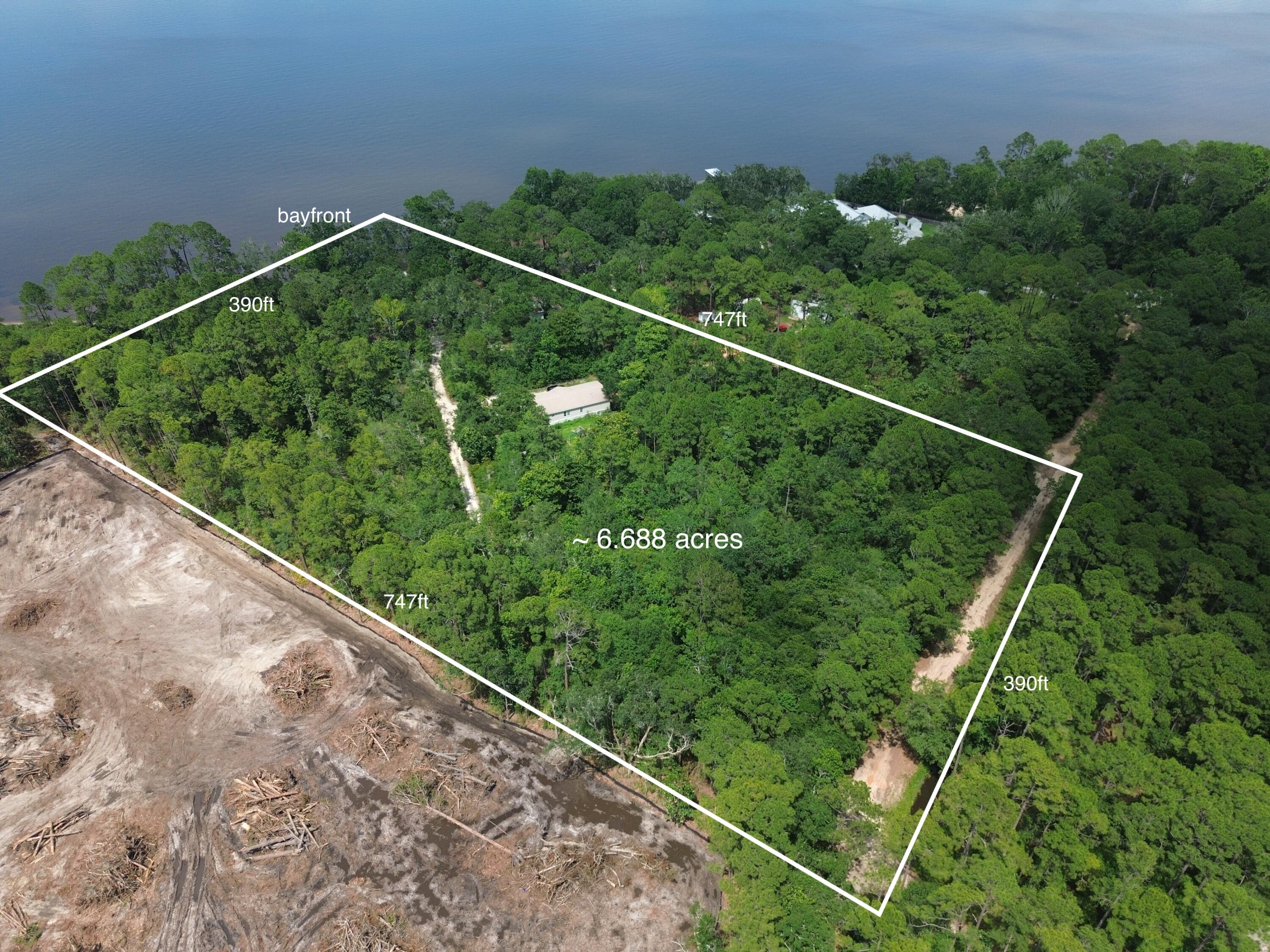 This  is a rare opportunity to own a 6.68 acre property that kisses the bay. Maps indicate about 130-150ft of waterfront. Oaks, Pines and Southern Magnolias dot the property throughout. Current zoning is Neighborhood Infill, up to 8 units per acre. Property could be used for one large estate size spectacular homesite overlooking the water, or work with the county to further develop.  Underground power is at the property. 

To the south of this property is the Kellogg Nature Center with parking and trail to the Kellogg Bay front Park. Coming soon is a new discovery building.

To see the property in person, 24 hour advanced notice required to view the property. Owners live at the property. Call your agent to schedule a time to see the property in person. NO DRIVE BY.